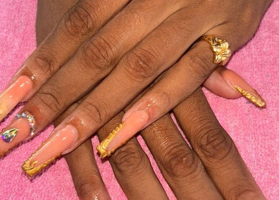 Elegant golden-accented nails at Creative Theia, Georgetown, Demerara-Mahaica, GY. Perfect for a stylish look.