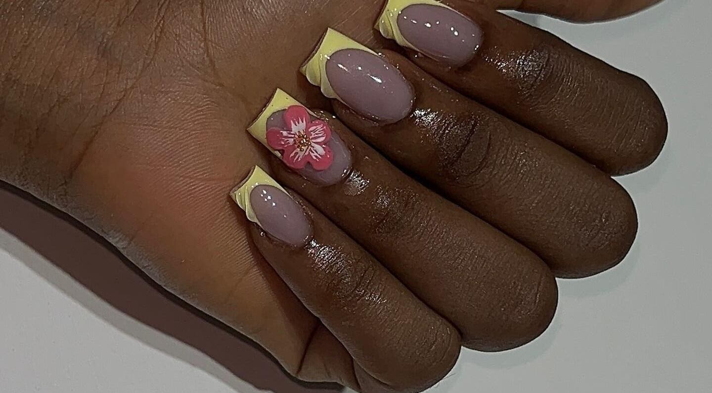 Stylish floral nail design at nailsbyyinkaa, Lagos, Lagos, NG. Featuring intricate pink flower accents.