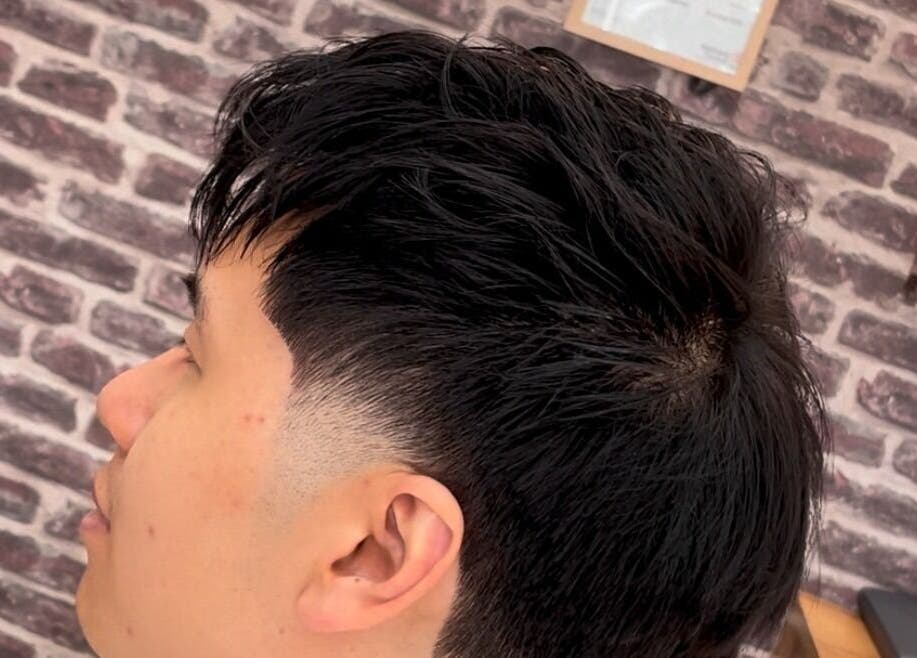 Close-up of a sleek fade hairstyle at D' Shaver And Comb Barbershop, Auckland, Auckland, NZ.