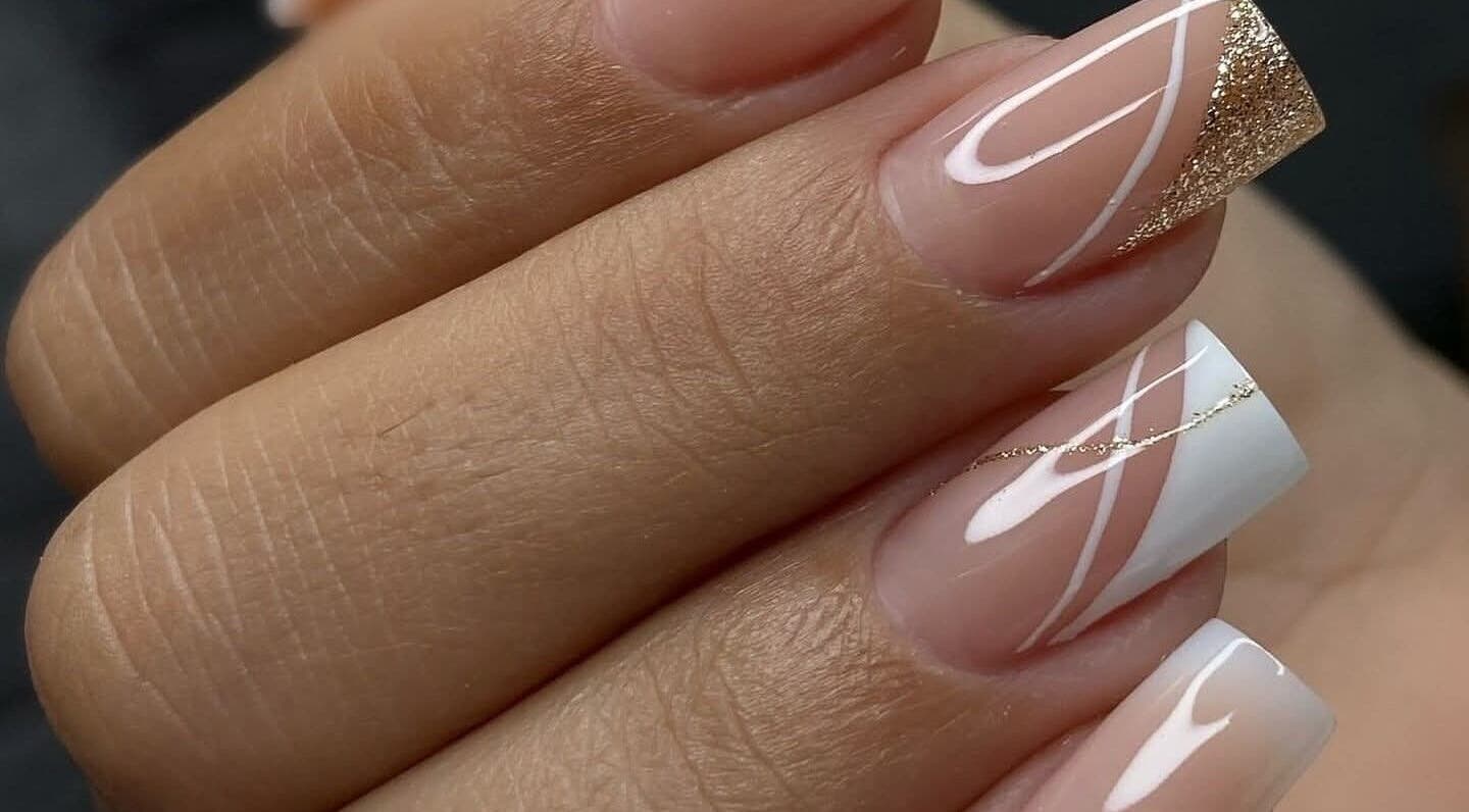 Elegant nail art with gold accents at Jenny Agudelo, CO showcasing stylish manicure.