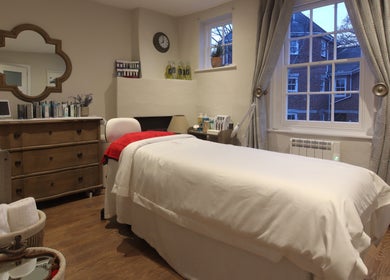 Relaxing treatment room at Luxury Bubble Fordingbridge, Fordingbridge, England, GB, featuring a cozy bed.