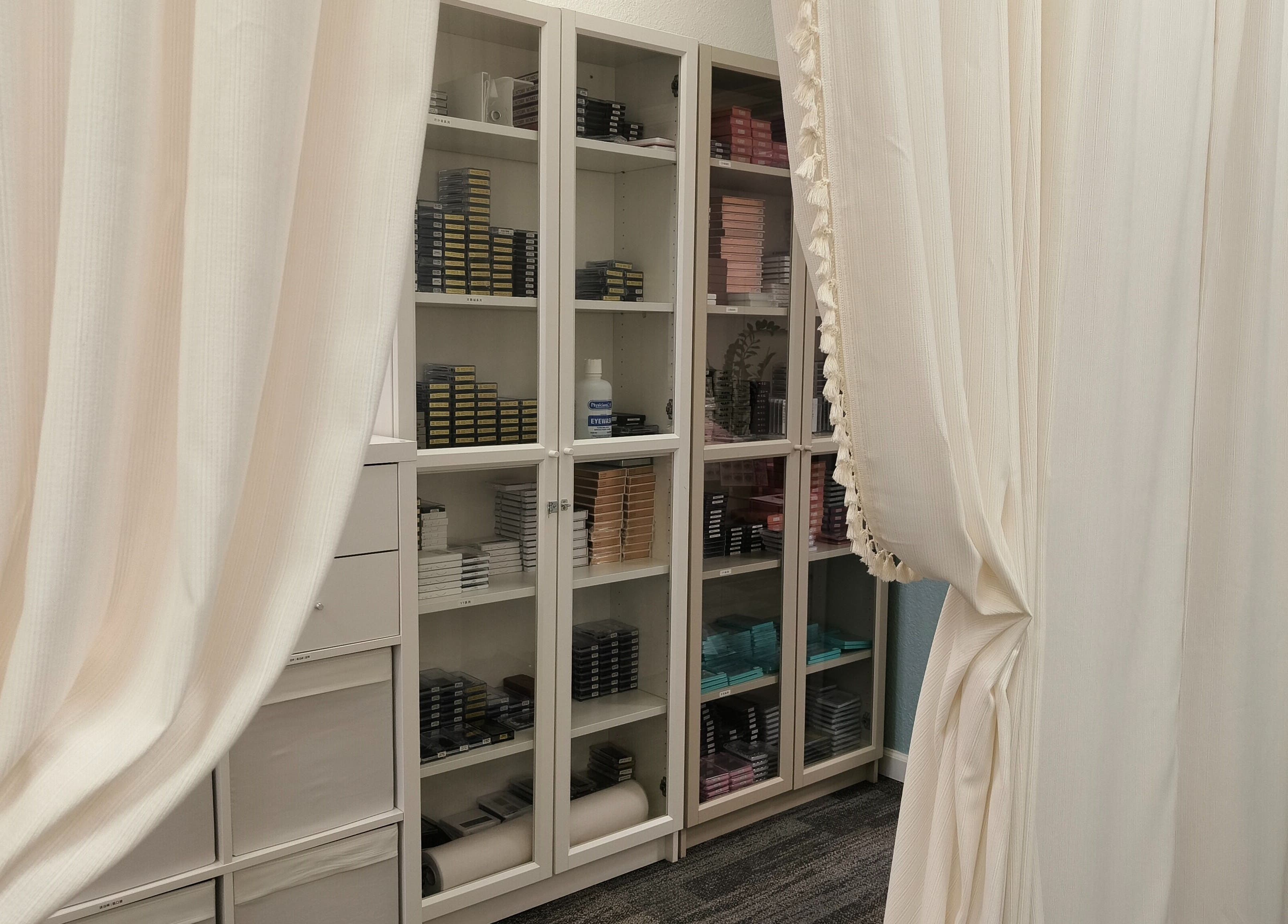 Organized beauty shelves at Catchy EyeDol Lash & Beauty in Fremont, California, US, behind elegant curtains.