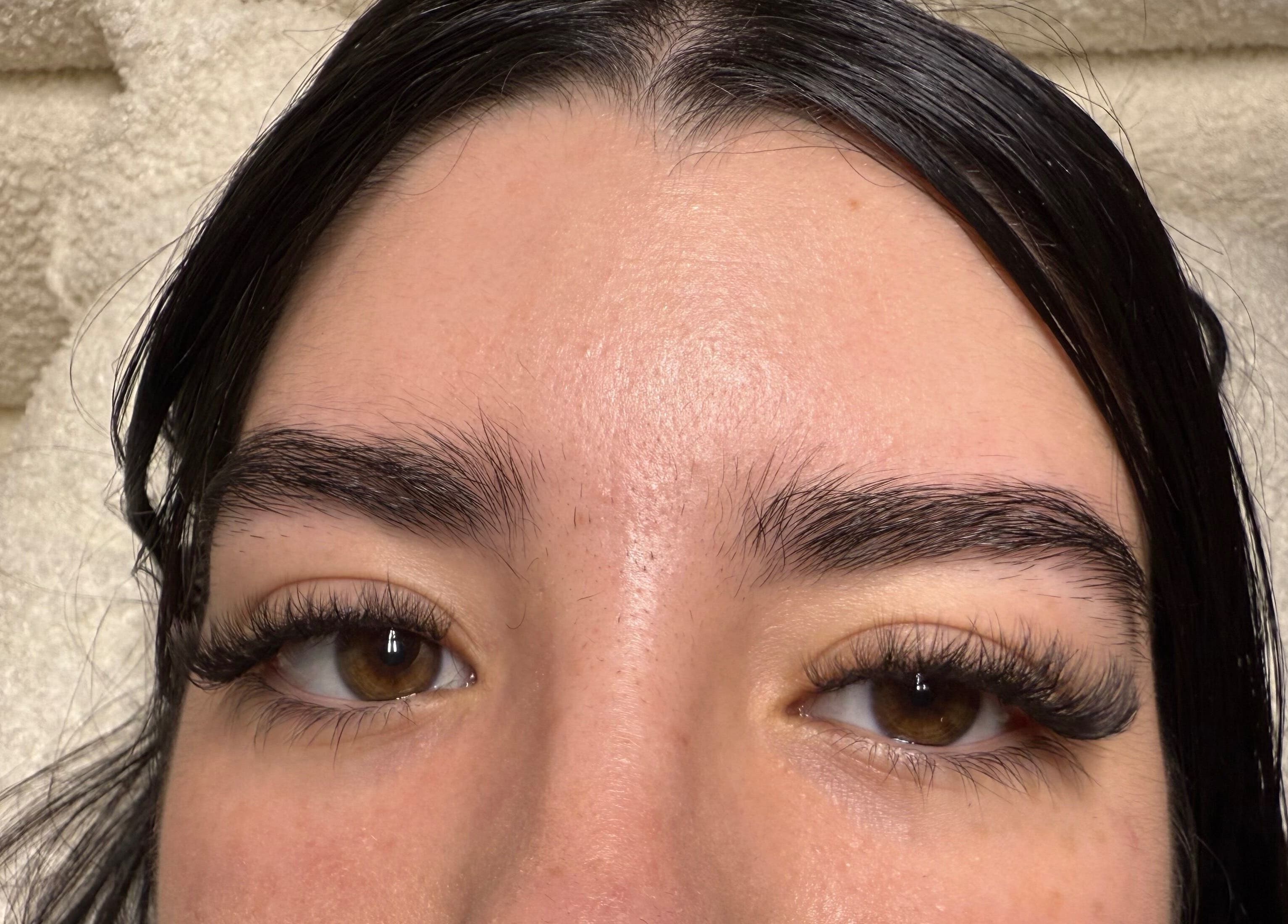 Close-up of eyelashes after treatment at dnl_lash_studio in Hialeah, Florida, US on a cozy towel background.