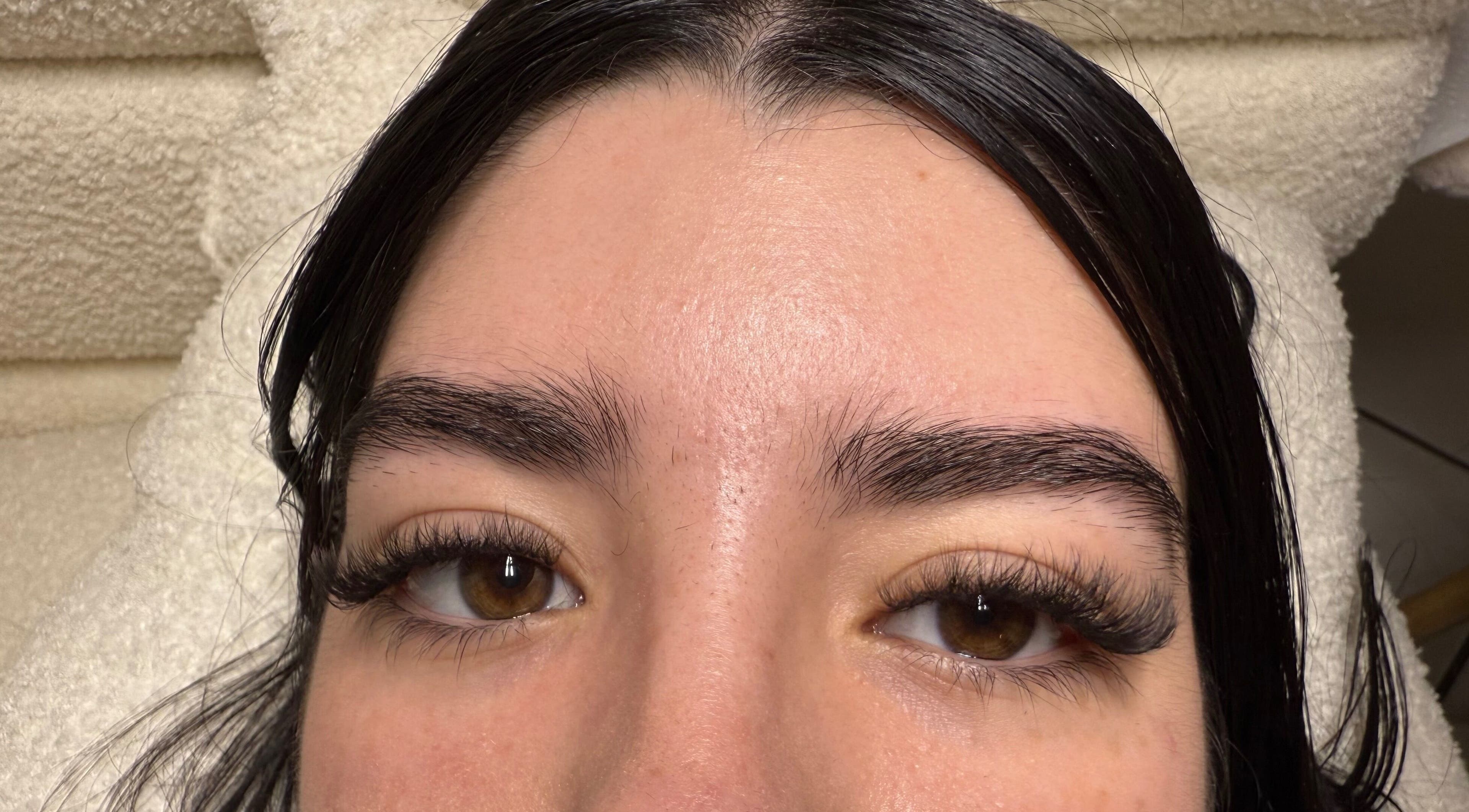 Close-up of eyelashes after treatment at dnl_lash_studio in Hialeah, Florida, US on a cozy towel background.