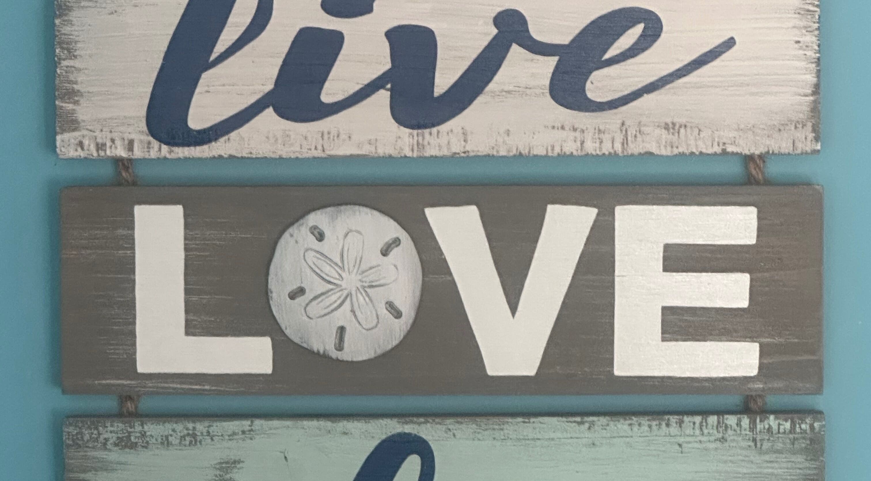 Decorative sign reading 'live love laugh' at S&B CLUB, Richmond Hill, Ontario, CA.