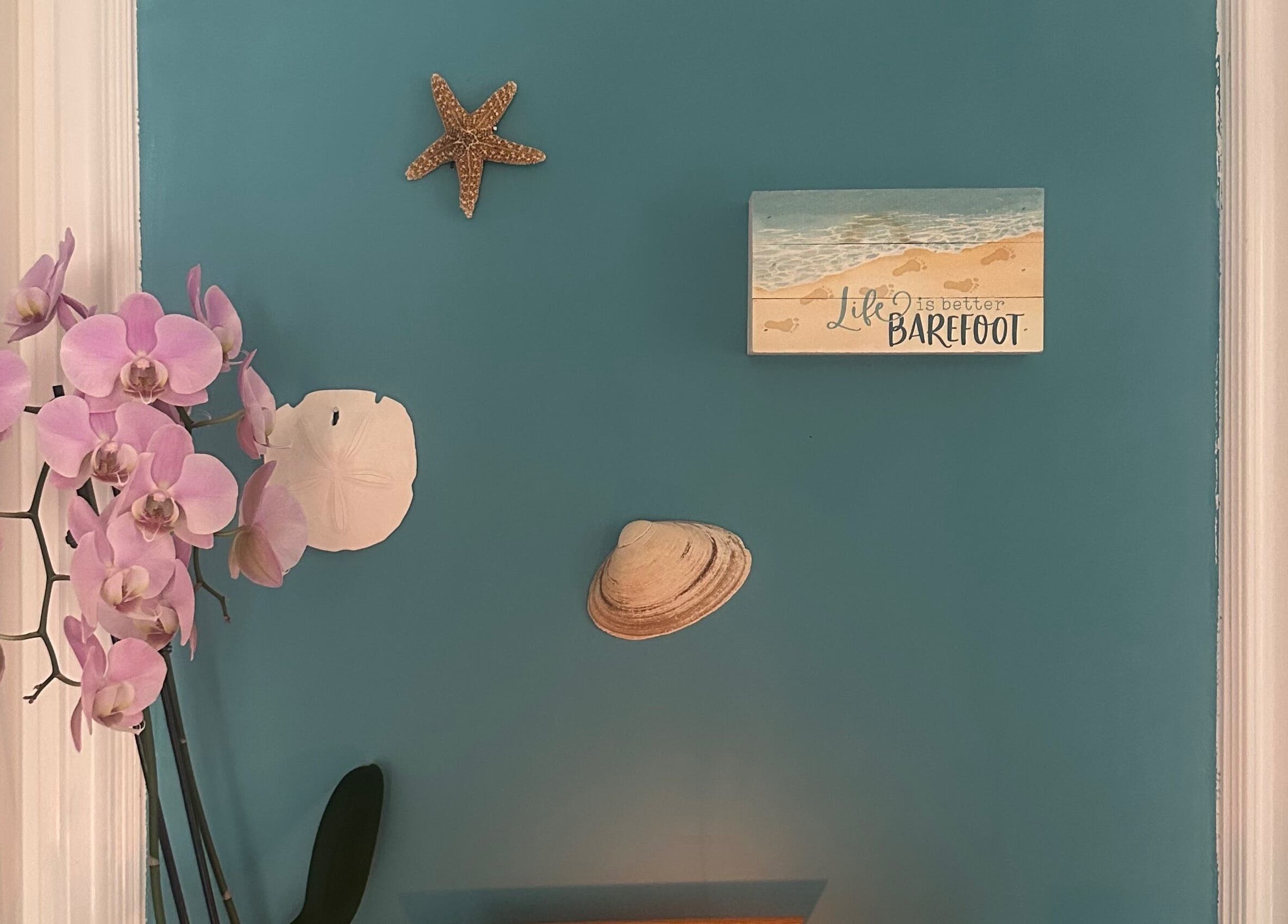 Pink orchids and beach decor create a serene ambiance at S&B CLUB, Richmond Hill, Ontario, CA.