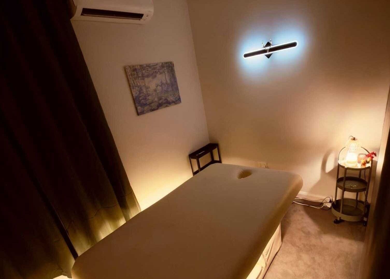 Massage room at Six B Platinum, Zetland, New South Wales, AU, featuring a serene ambiance with dim lighting.