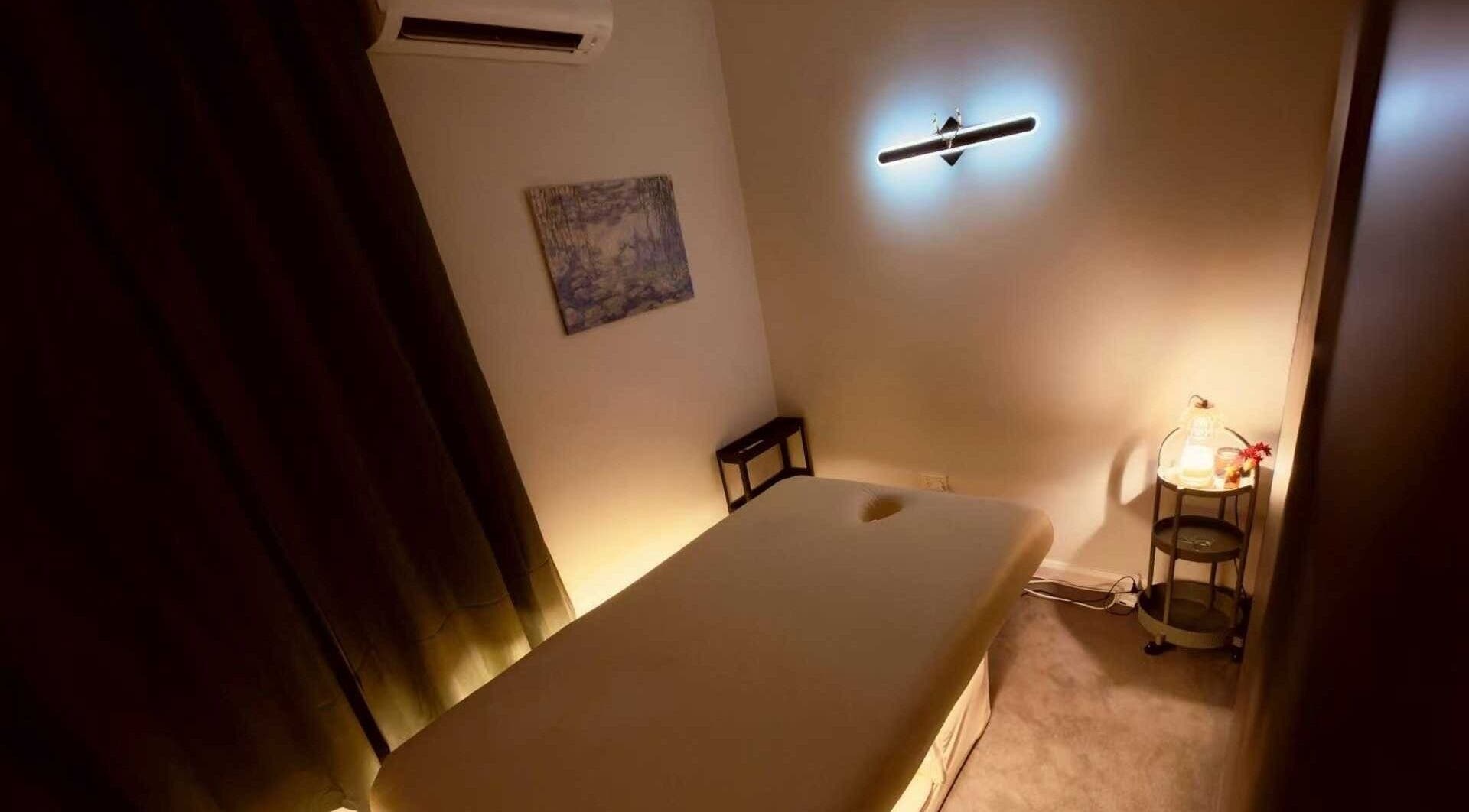 Massage room at Six B Platinum, Zetland, New South Wales, AU, featuring a serene ambiance with dim lighting.