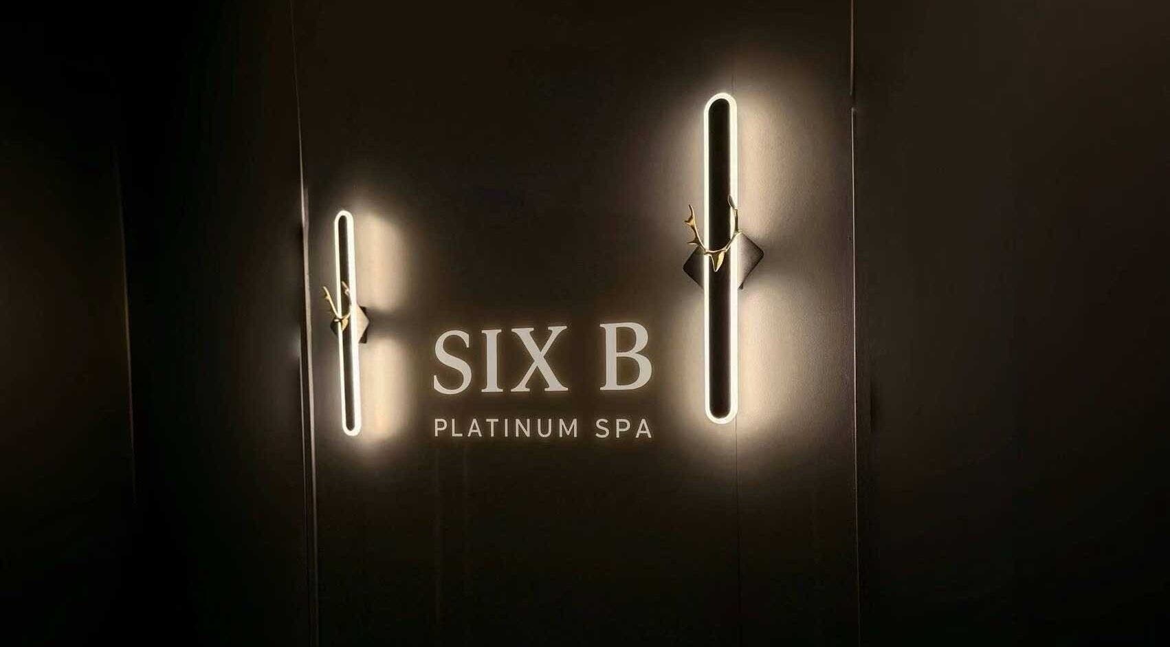 Illuminated Six B Platinum logo on a sleek wall in Zetland, New South Wales, AU. Modern luxury spa setting.