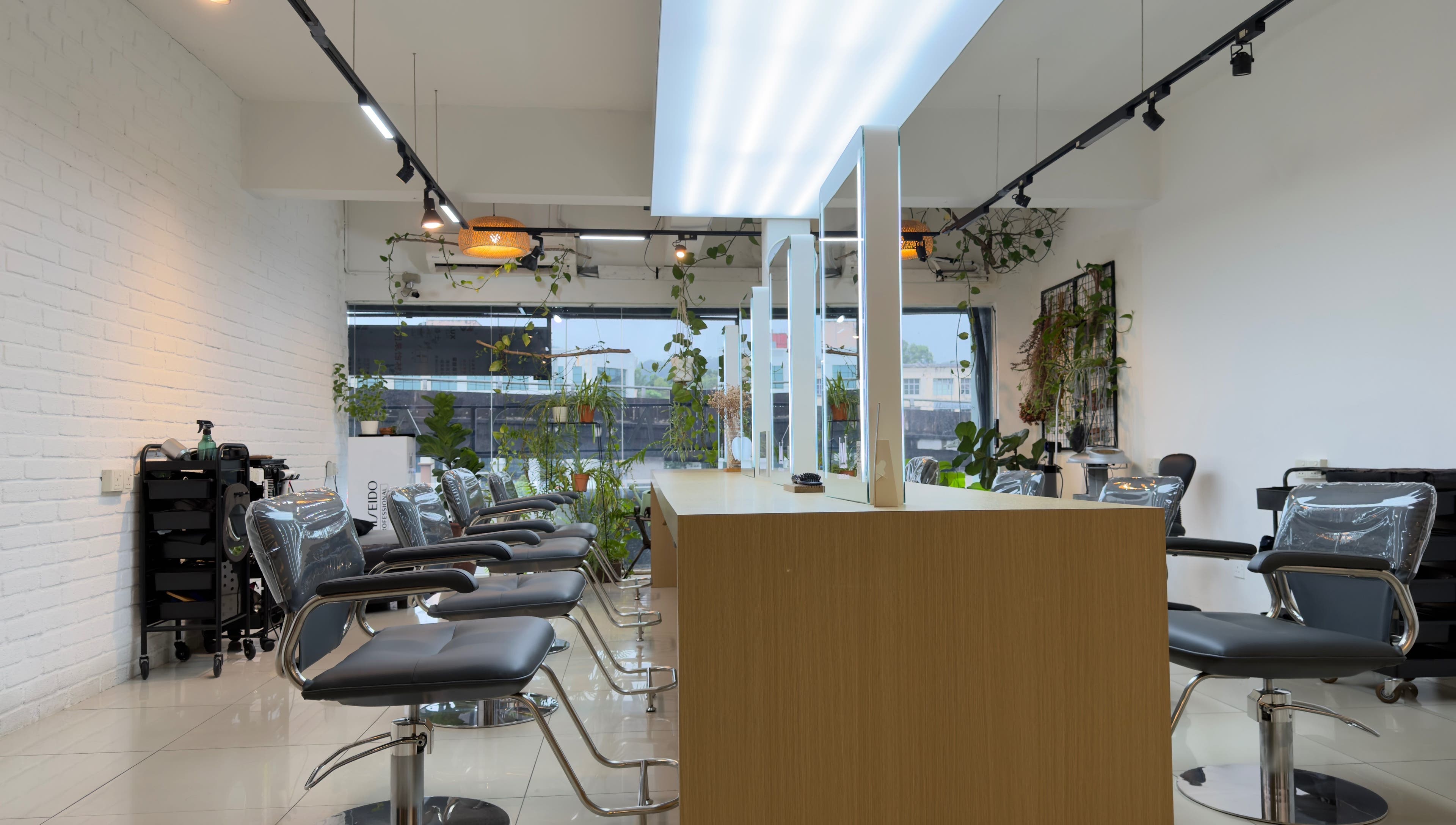Modern salon interior at M Square Lifestyle Salon HQ, Puchong, Selangor, MY with stylish chairs and greenery.
