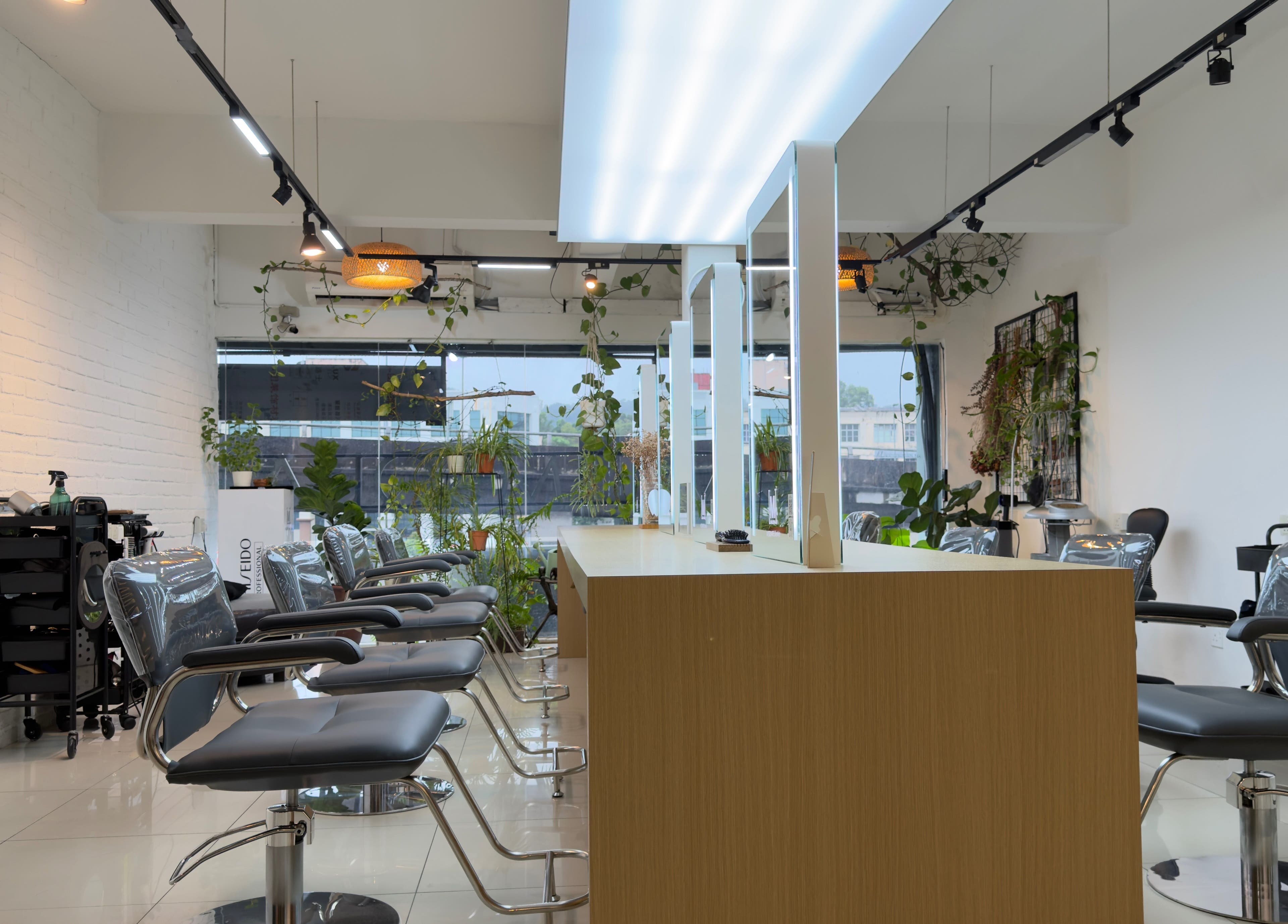 Modern salon interior at M Square Lifestyle Salon HQ, Puchong, Selangor, MY with stylish chairs and greenery.