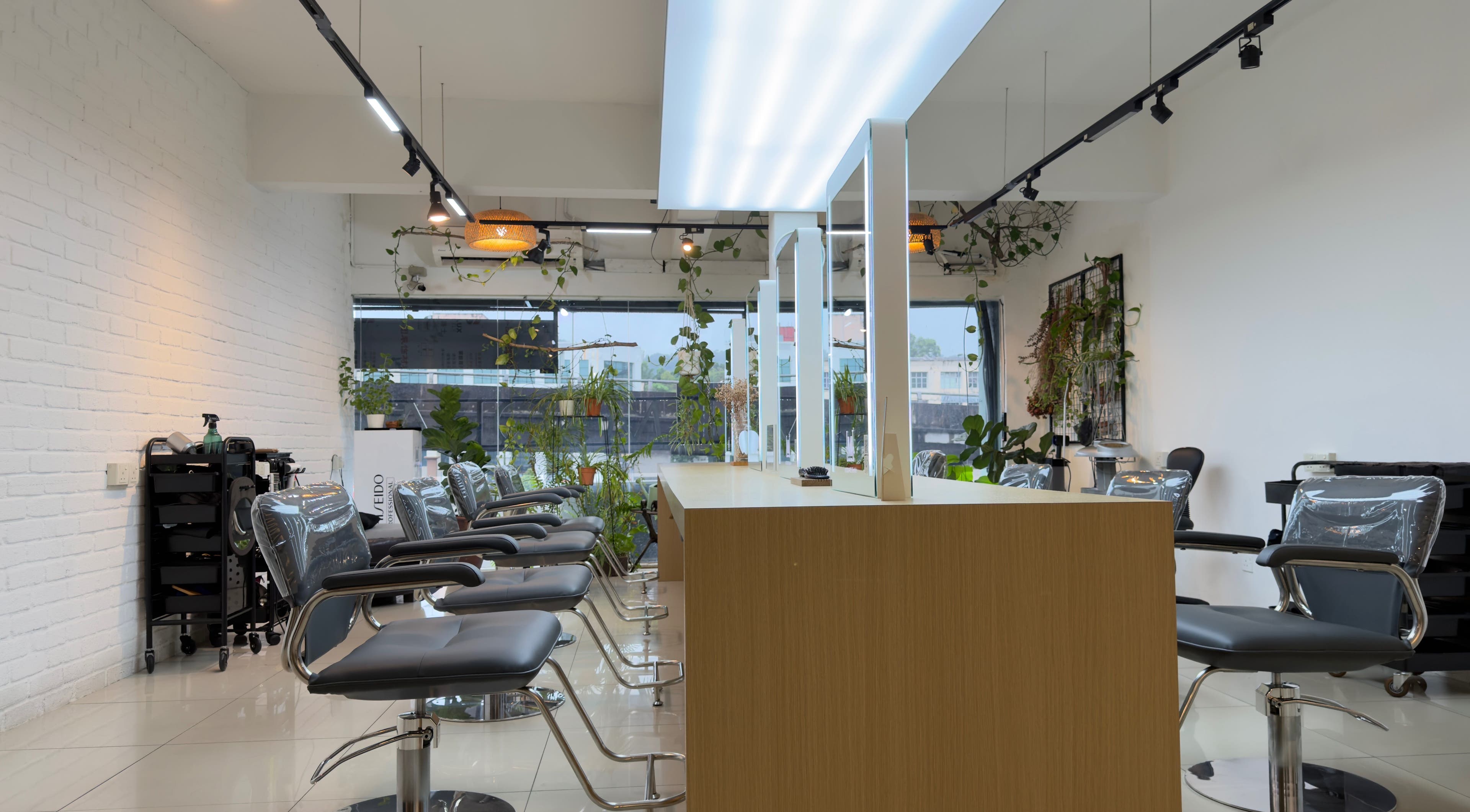 Modern salon interior at M Square Lifestyle Salon HQ, Puchong, Selangor, MY with stylish chairs and greenery.