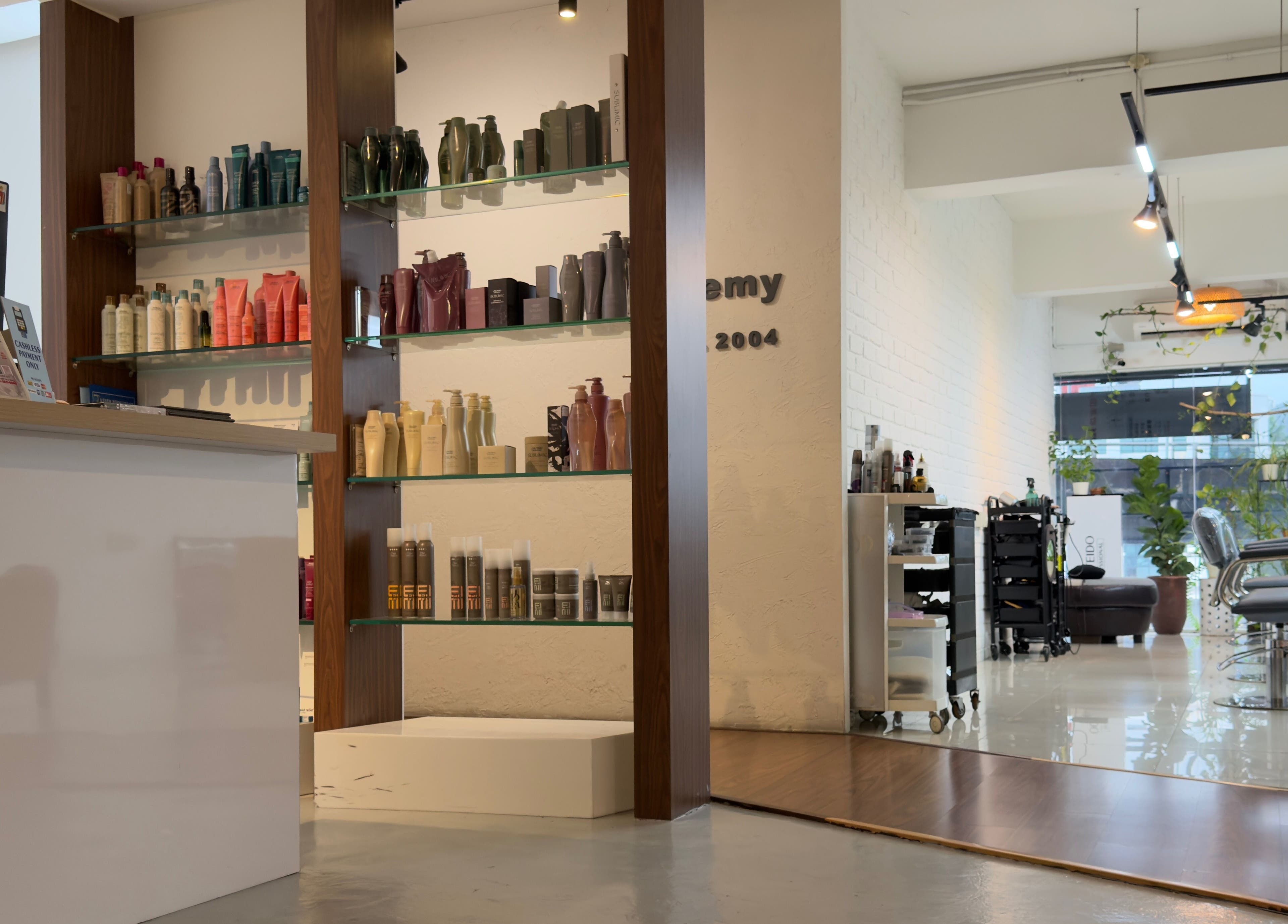 Modern interior of M Square Lifestyle Salon HQ in Puchong, Selangor, MY, showcasing hair products and styling chairs.