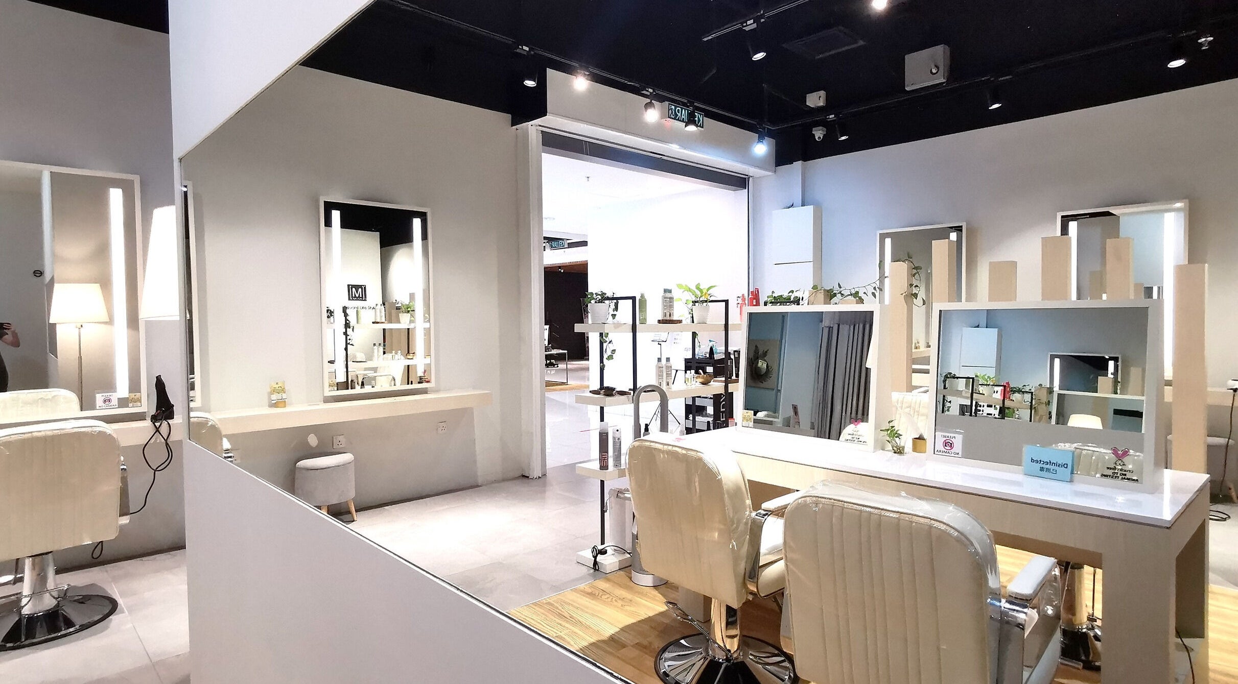Modern salon interior at M SQUARE LIFESTYLE SALON, Kuala Lumpur, featuring sleek styling stations and mirrors.