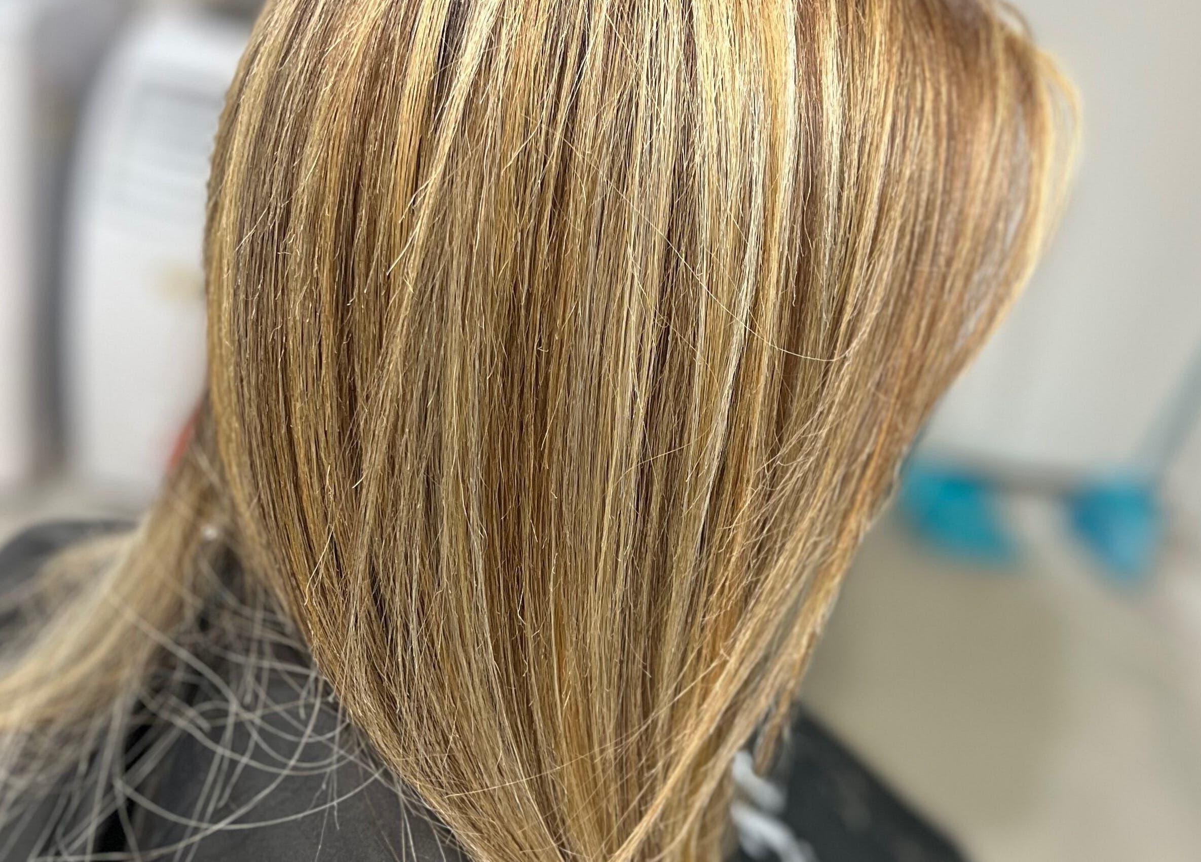 Blonde highlights styled at Hair By Yamen, Melbourne, Victoria, AU, showcasing sleek salon finish.