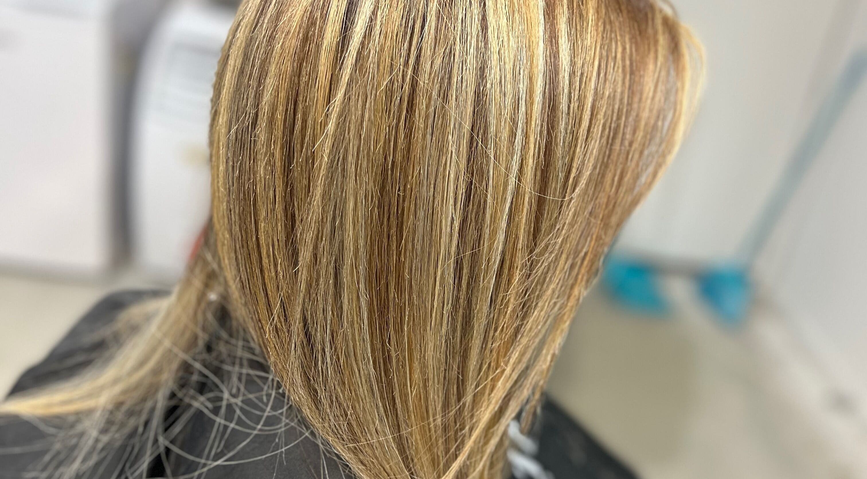 Blonde highlights styled at Hair By Yamen, Melbourne, Victoria, AU, showcasing sleek salon finish.
