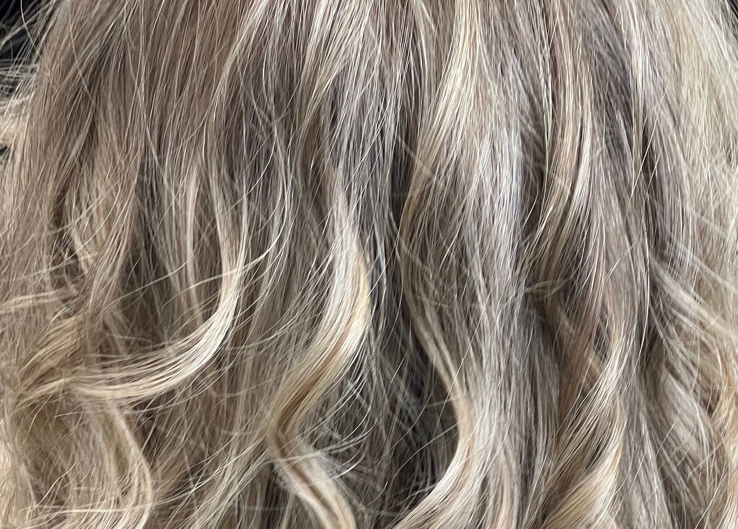 Blond wavy hairstyle at Hair By Yamen in Melbourne, Victoria, AU, showcasing expertly styled curls.