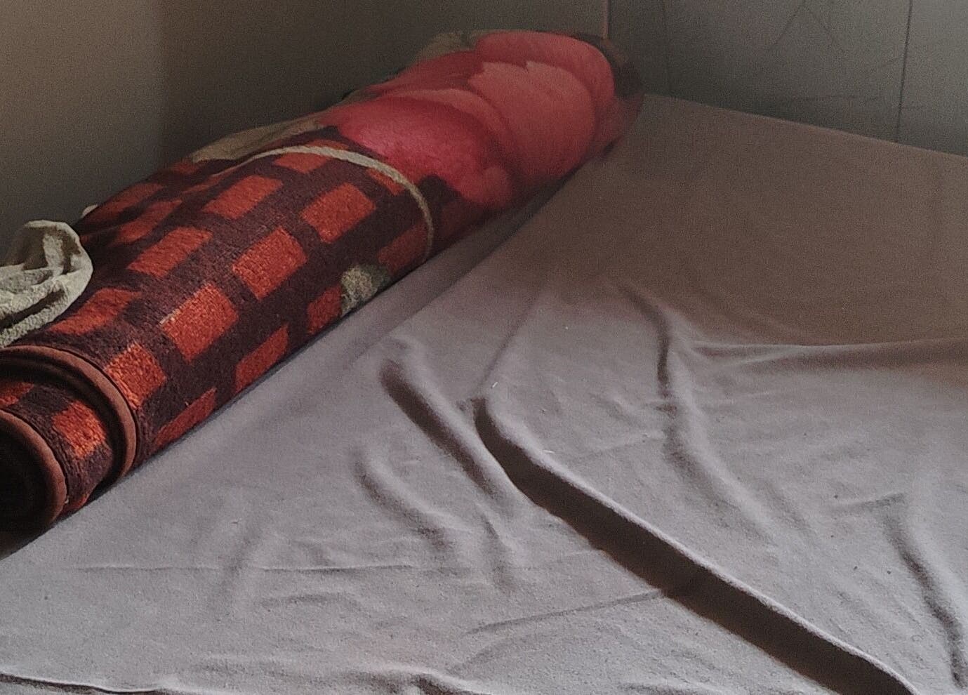 Rolled blanket on massage table at Lokal massage home service in Mumbai, IN.