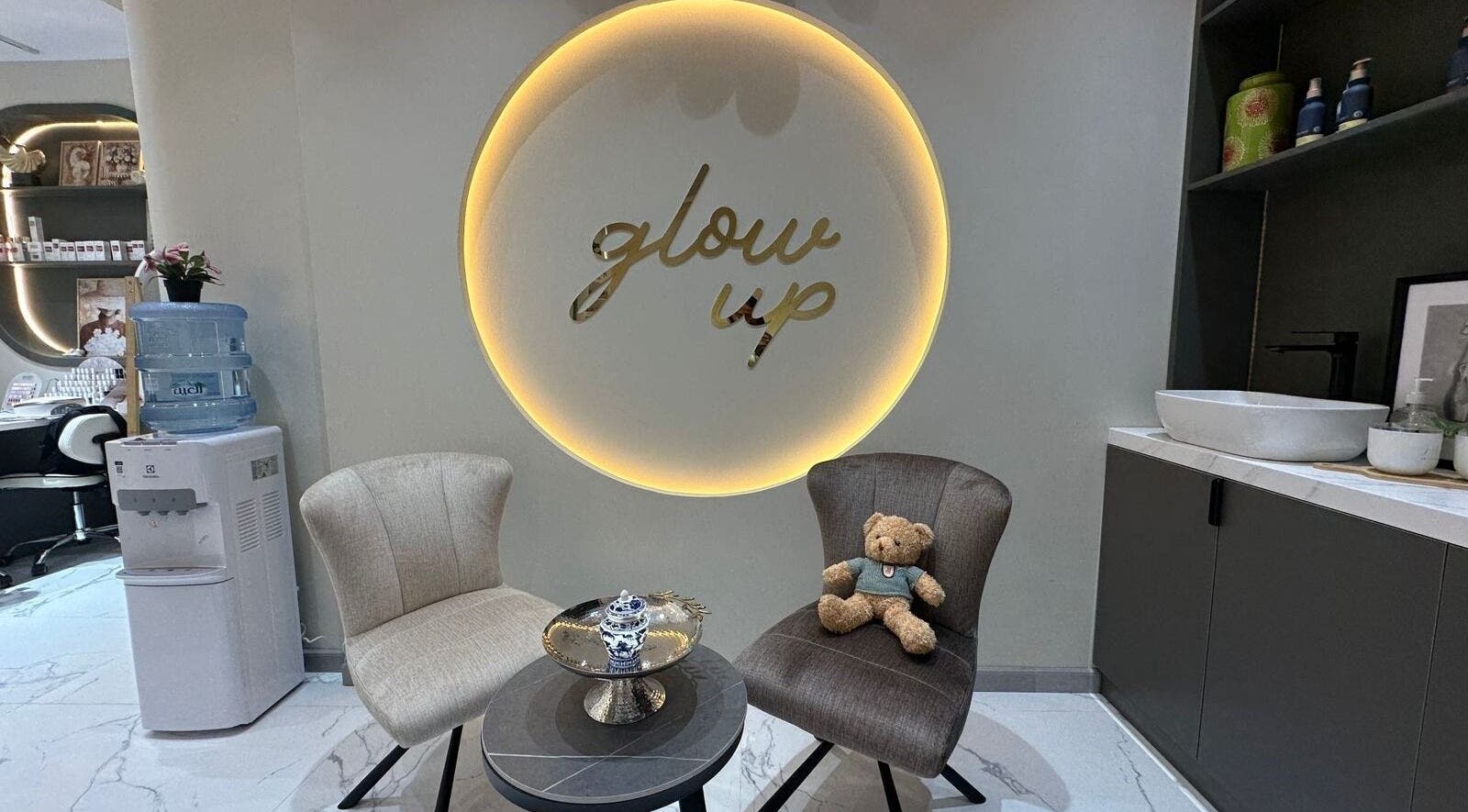 Inviting seating area at Allenora Beauty Lounge, Abu Dhabi, AE with glow up sign and chic decor.
