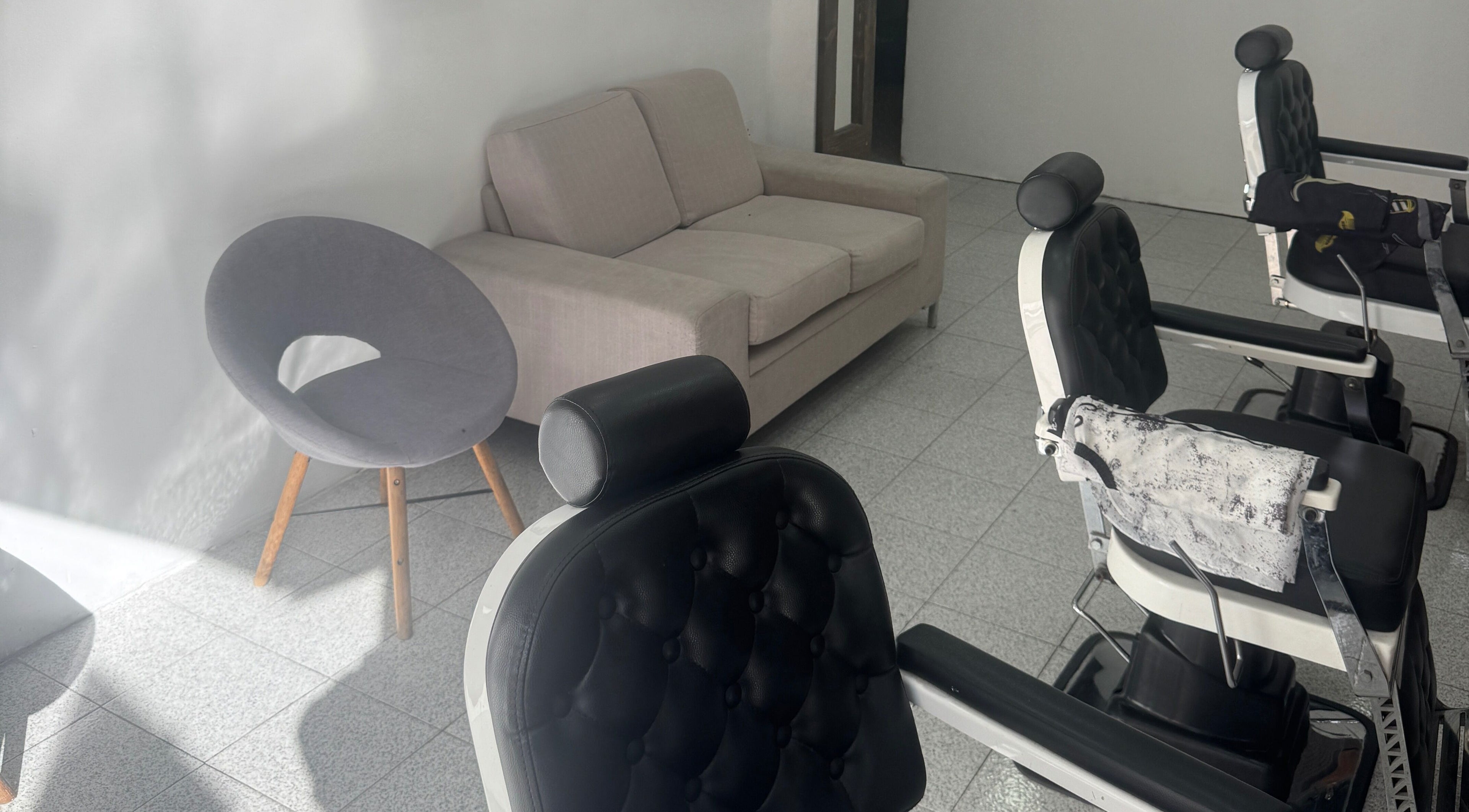 Relaxing seating area next to stylish barber chairs at Casablanca barbershop, Il-ħamrun, MT.