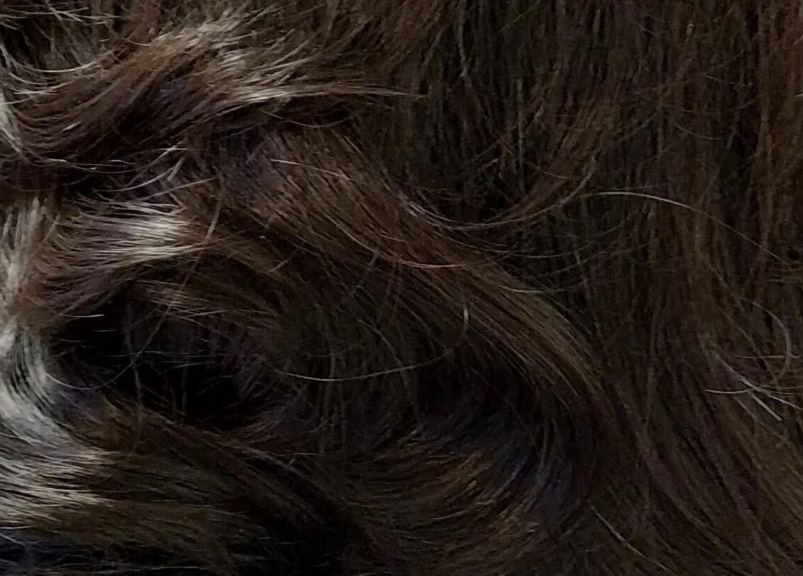Close-up of styled dark hair waves at Hair by Dalton, Nicholas Mark Hairdressing, Newcastle upon Tyne, England.