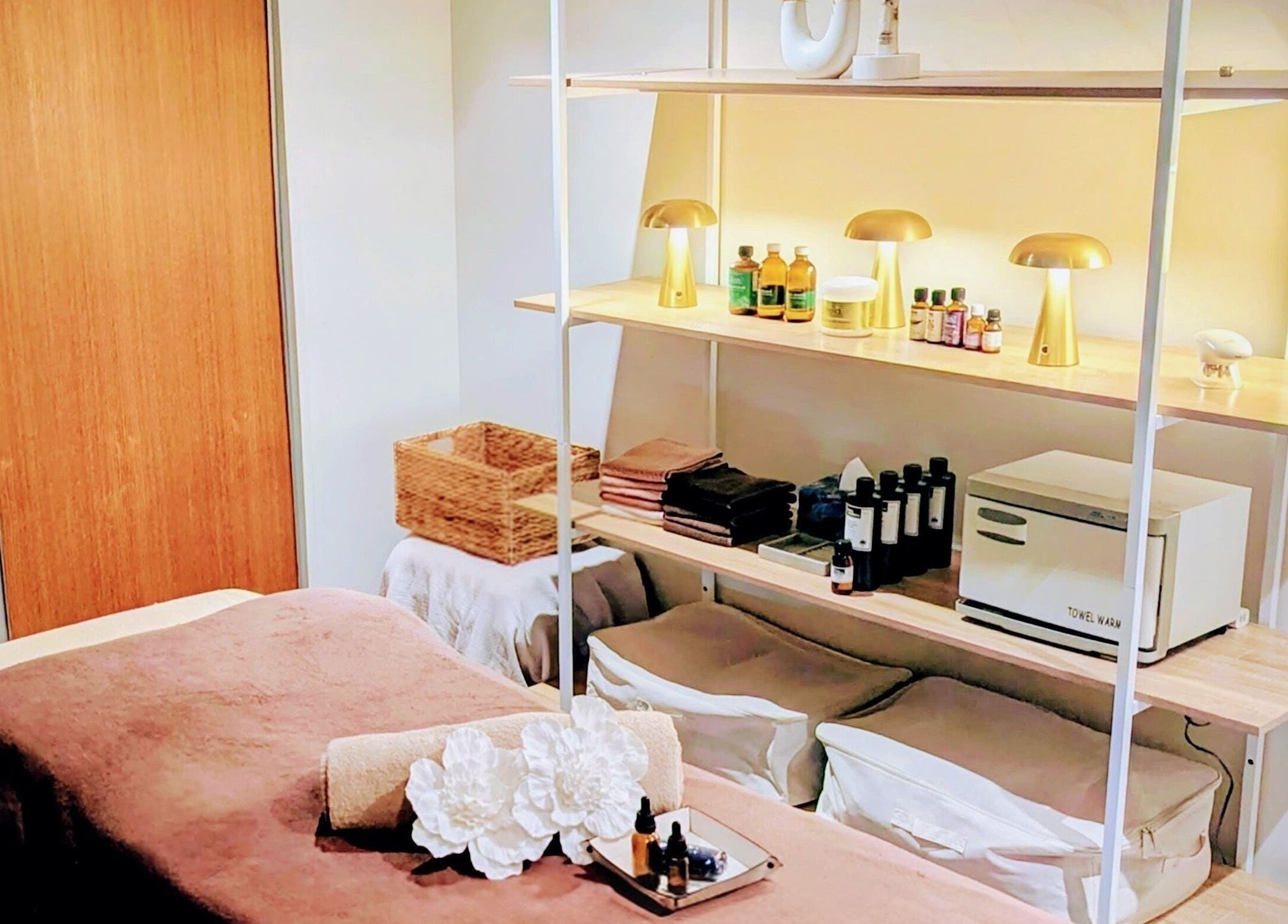 Elegantly decorated therapy room at Total Body Care Salon BLESS, Auckland, NZ, featuring cozy ambiance and wellness essentials.