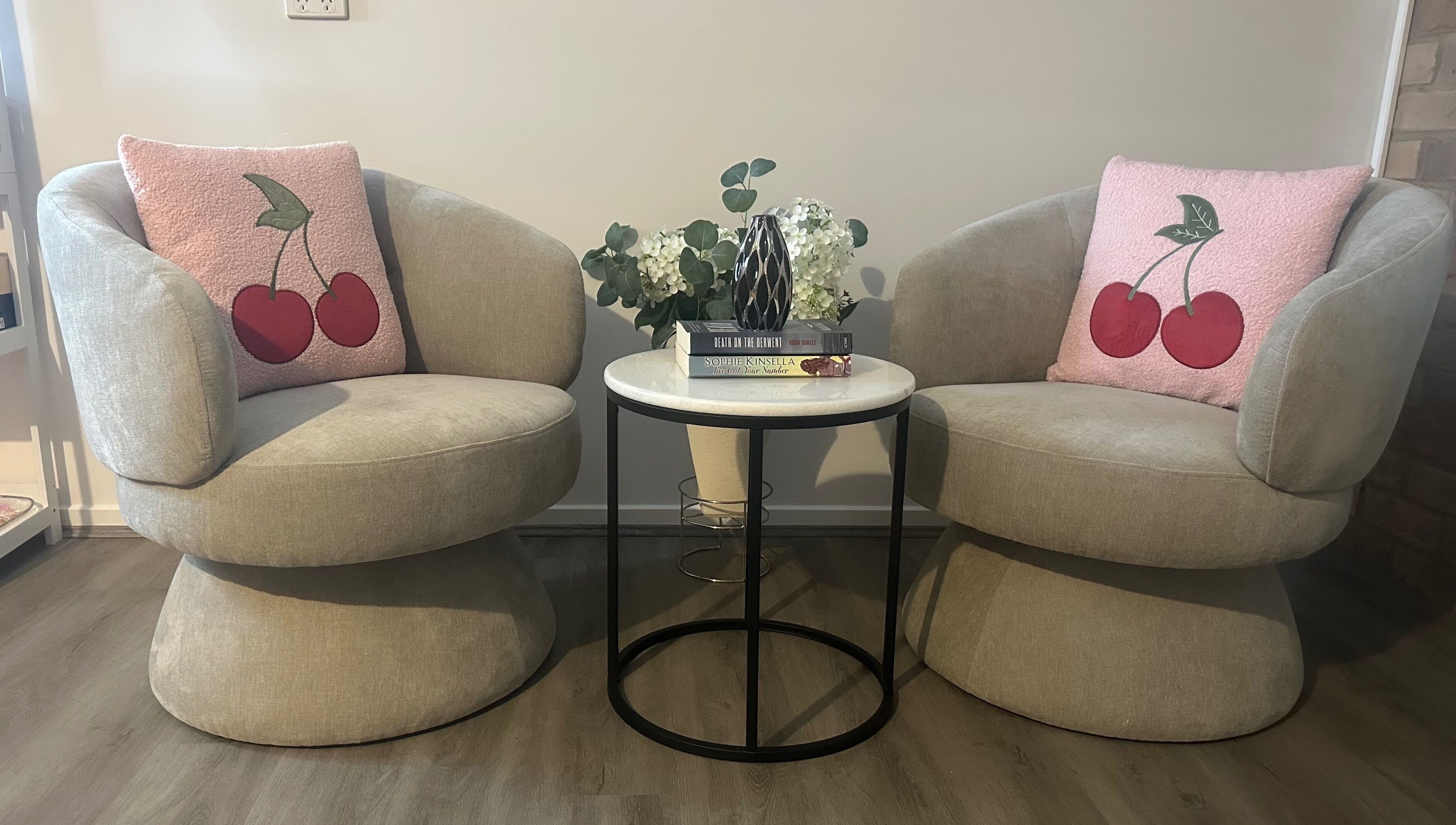 Cozy seating area with pink cherry cushions at Glow By Candice K, Melbourne, Victoria, AU.