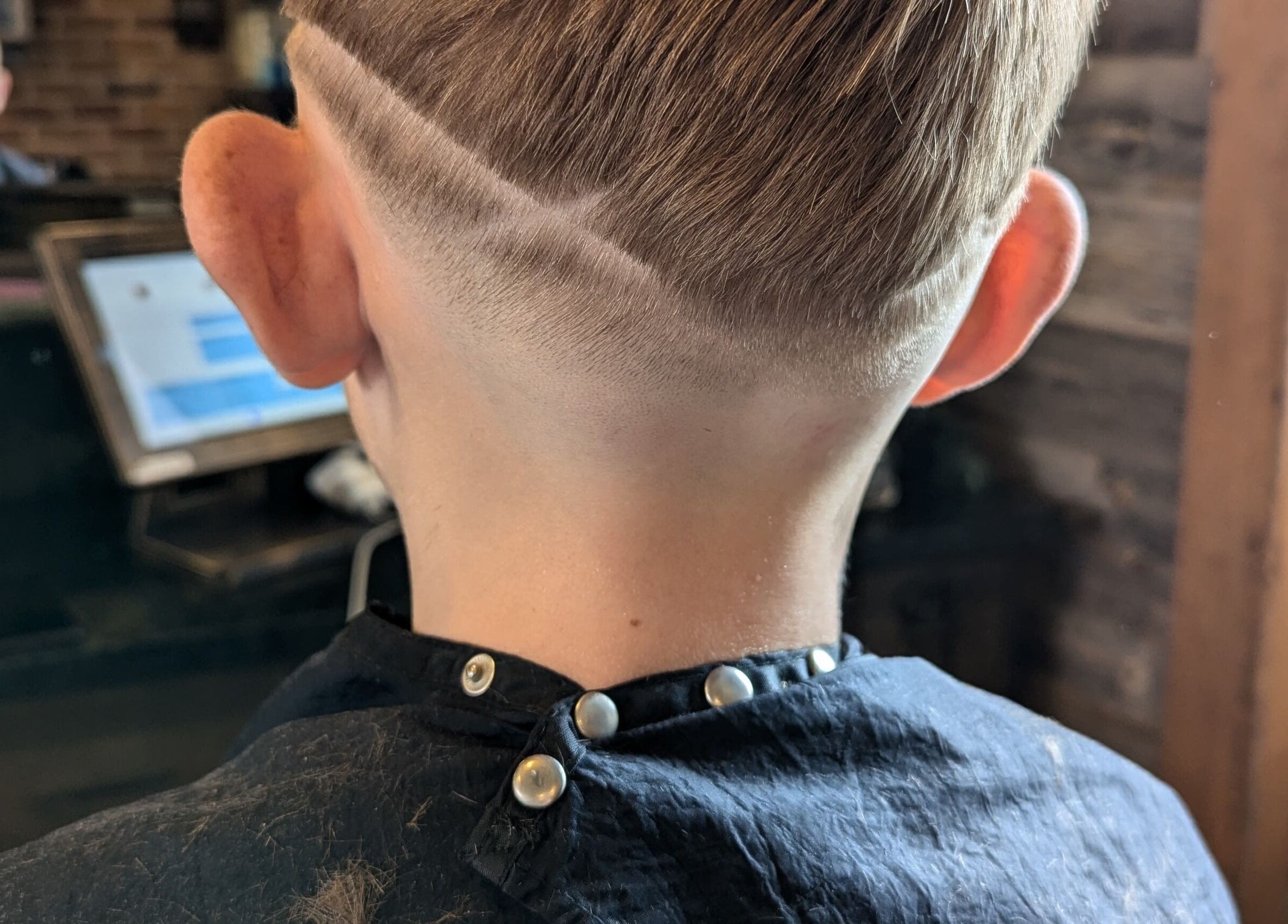 Fresh haircut with stylish design at JW BARBERING in Pembroke, Wales, GB.