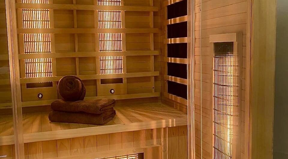Cozy sauna ambiance at Roll Studio in Boksburg, Gauteng, ZA, featuring wooden interiors and plush towels.