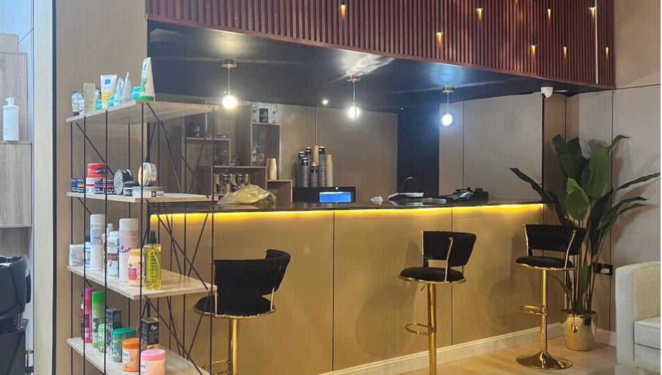 Chic interior of Billionaire Salon – Al Shati, Jeddah, showcasing elegant bar stools and beauty products.