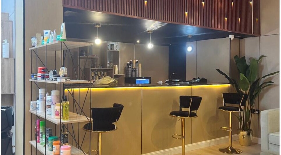 Chic interior of Billionaire Salon – Al Shati, Jeddah, showcasing elegant bar stools and beauty products.