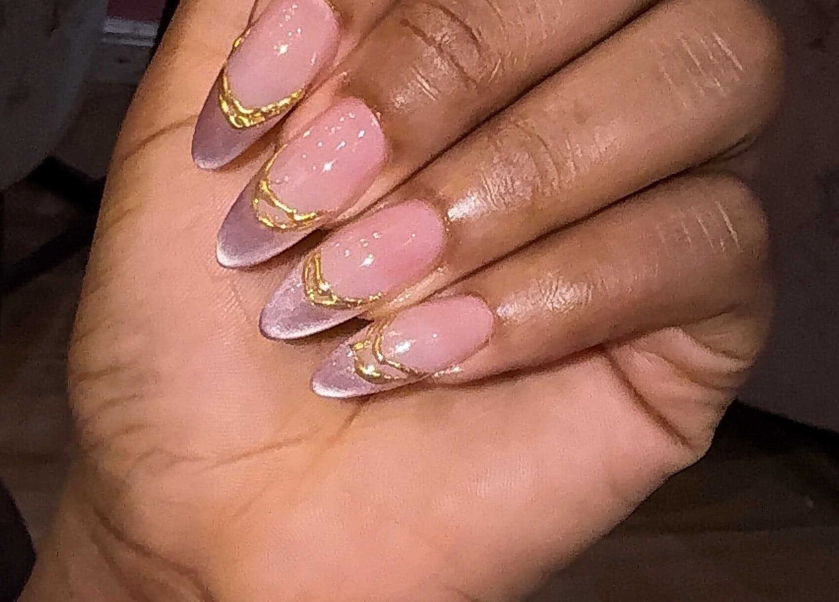 Manicured nails with pink polish and gold accents at Nailzby.ola, Lagos, Lagos, NG.