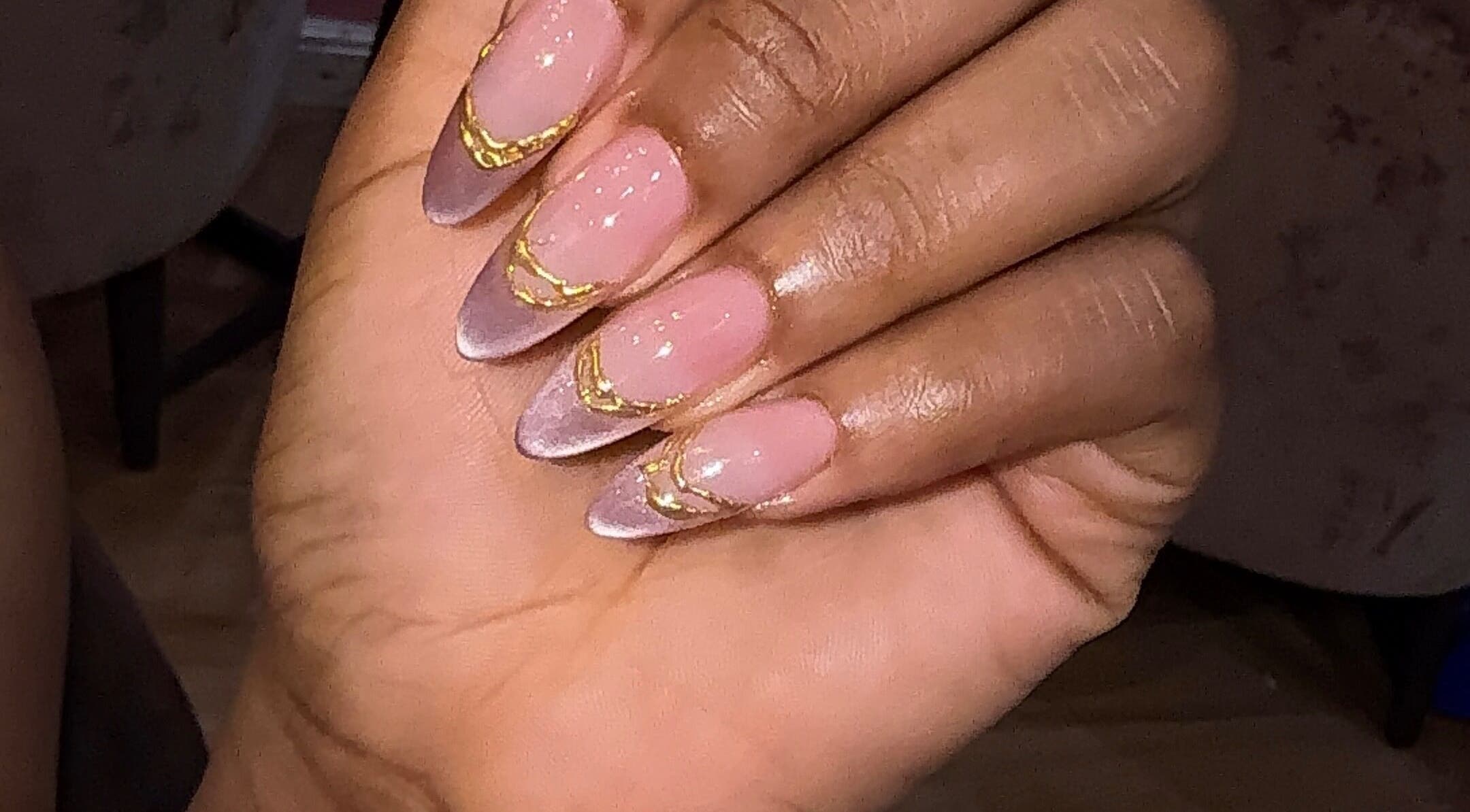 Manicured nails with pink polish and gold accents at Nailzby.ola, Lagos, Lagos, NG.