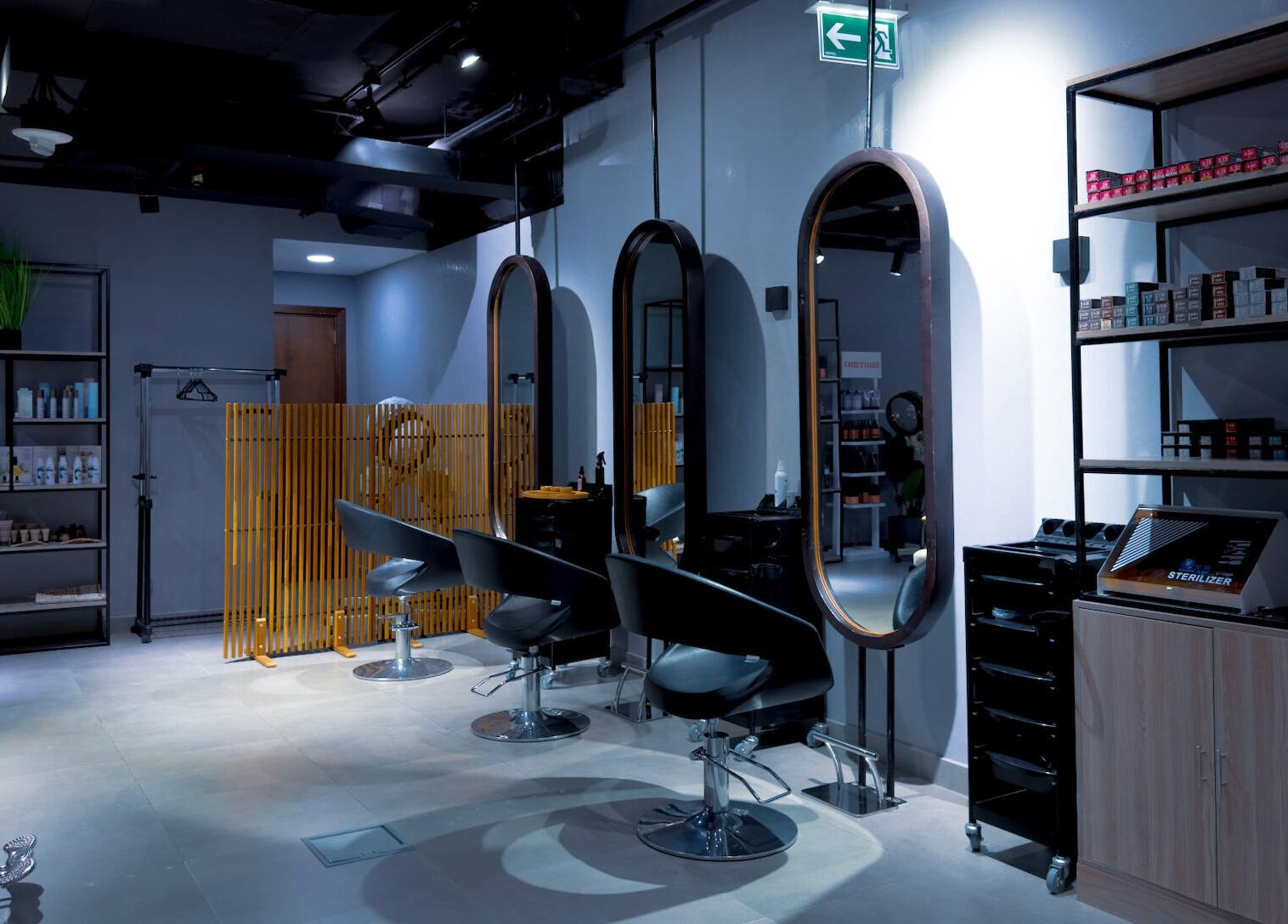 Chic interior of Painted Nails Beauty Salon in Abu Dhabi, AE with modern styling stations.