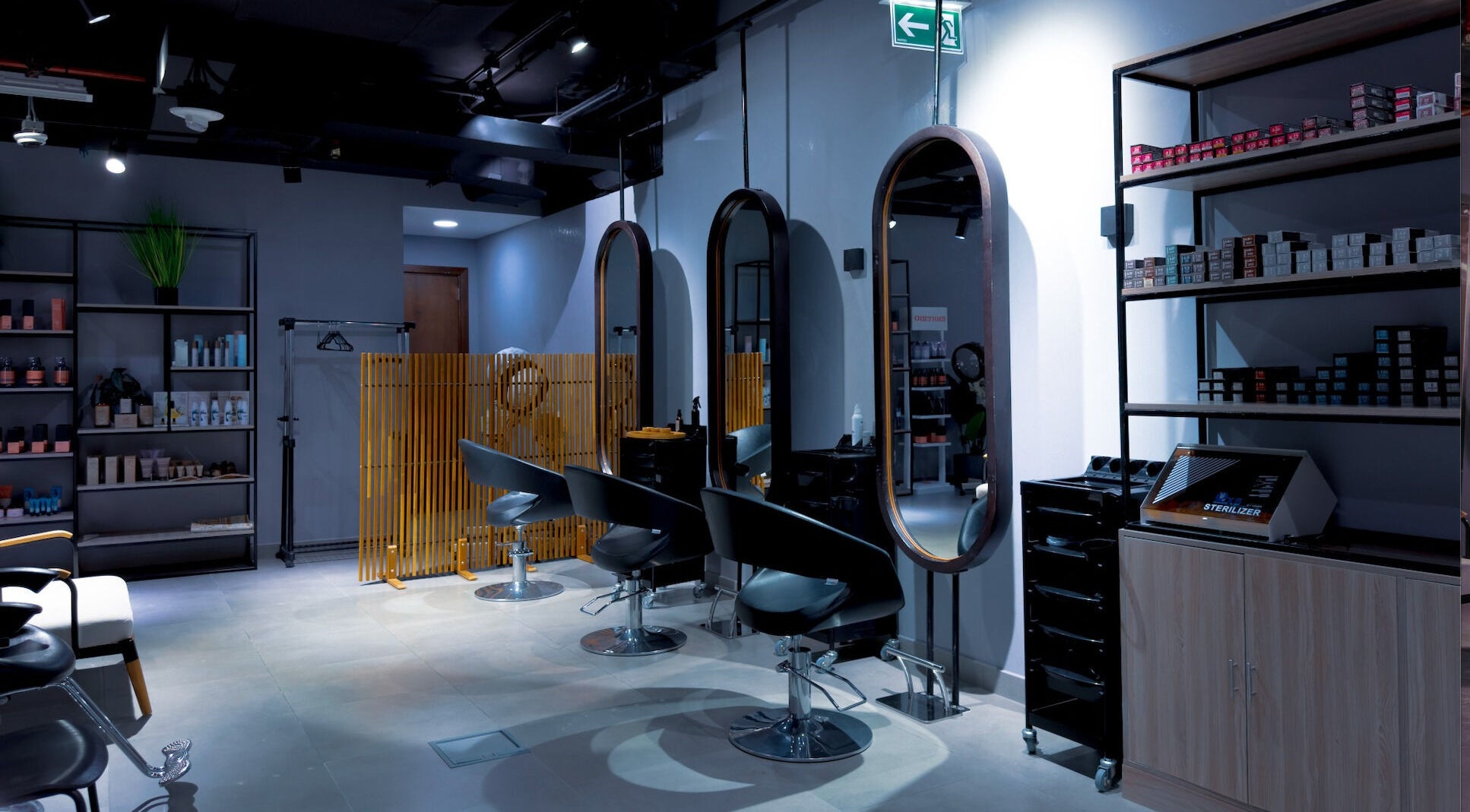 Modern interior of Painted Nails Beauty Salon in Abu Dhabi, AE featuring stylish chairs and products.