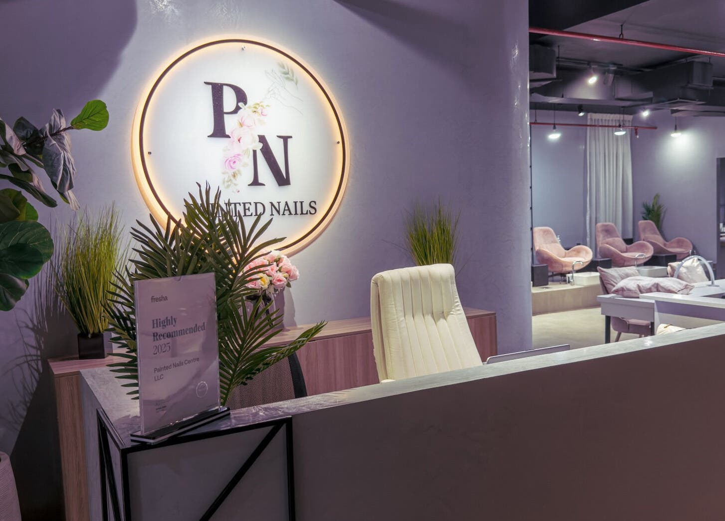 Elegant reception area at Painted Nails Beauty Salon, Abu Dhabi, AE, showcasing modern decor and seating.