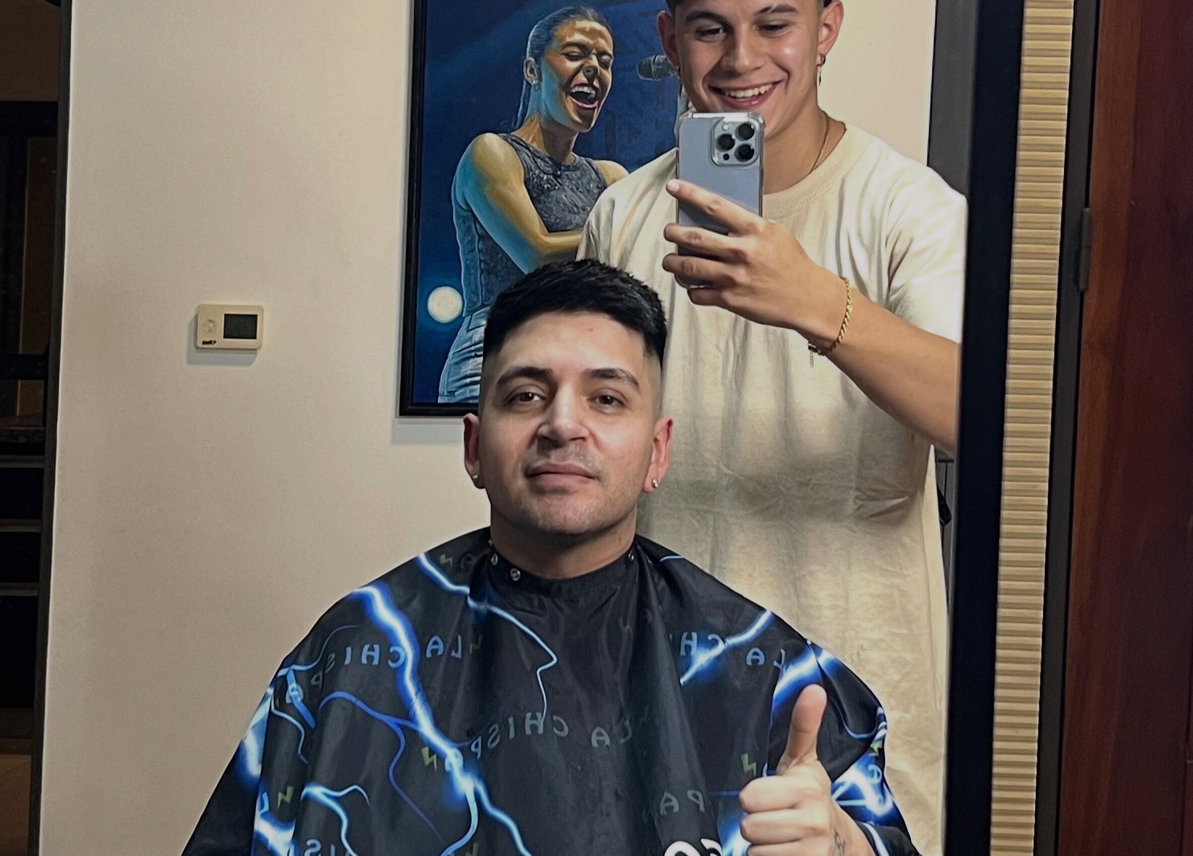 Happy customer receiving a haircut at Chispa Barberia, córdoba, AR showcasing style and satisfaction.