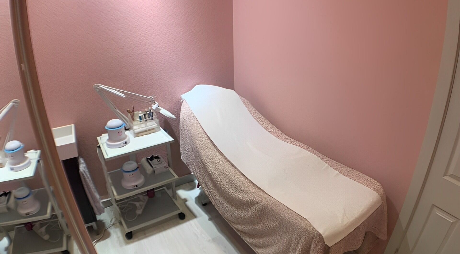 Cozy treatment room at Kalon Beauty, Clane, County Kildare, IE, featuring a massage table with pink decor.