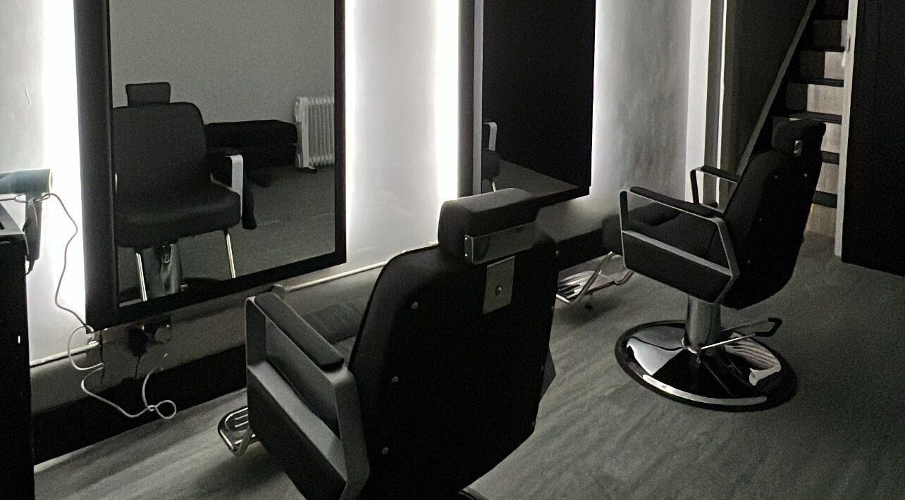 Modern salon chairs at The Stockroom, Henlow, England, GB, with sleek black design and large mirrors.