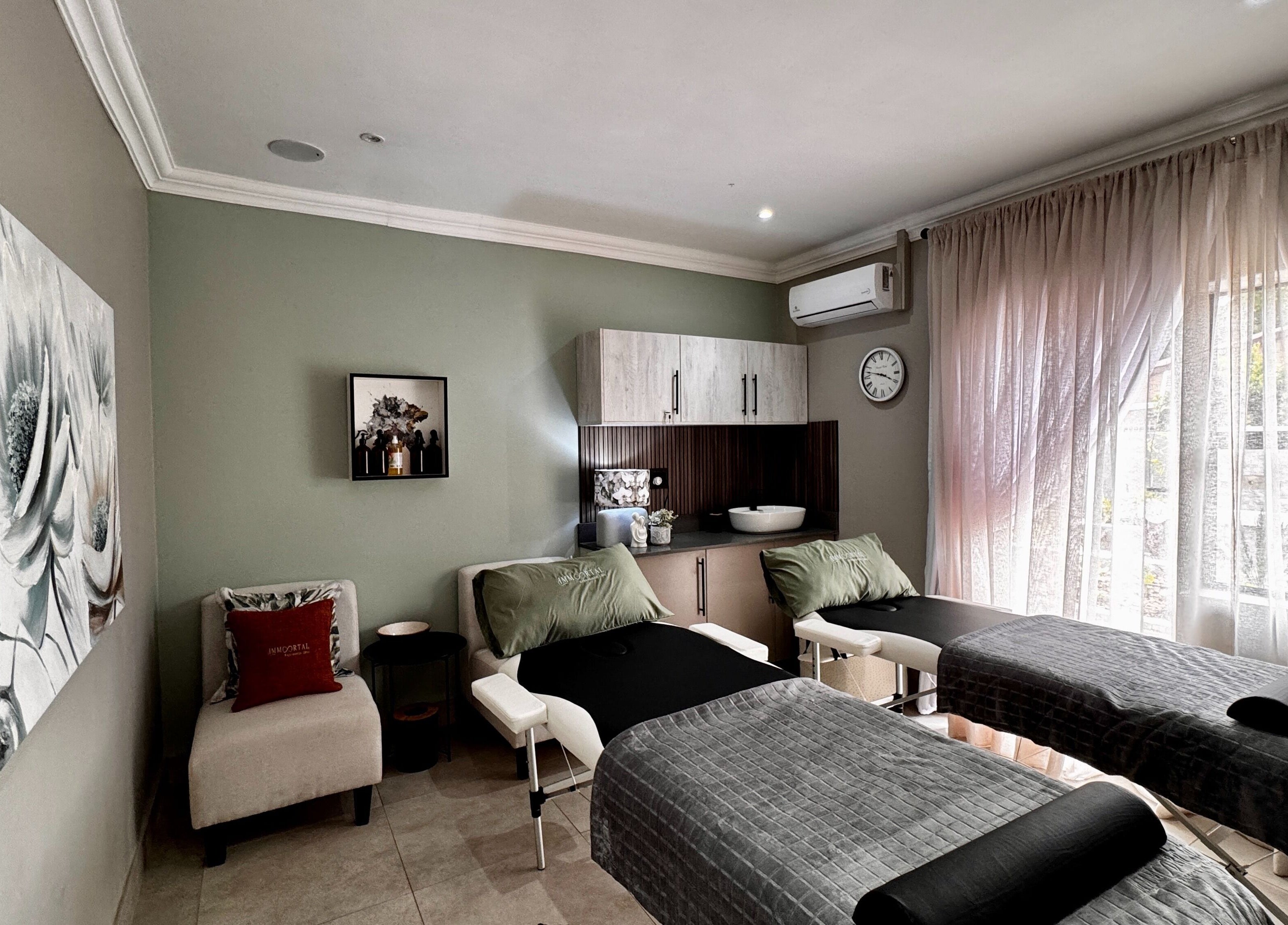Luxurious treatment room at Immortal Rejuvenation Clinic, Newcastle, Kwazulu-natal, ZA with massage tables and elegant decor.