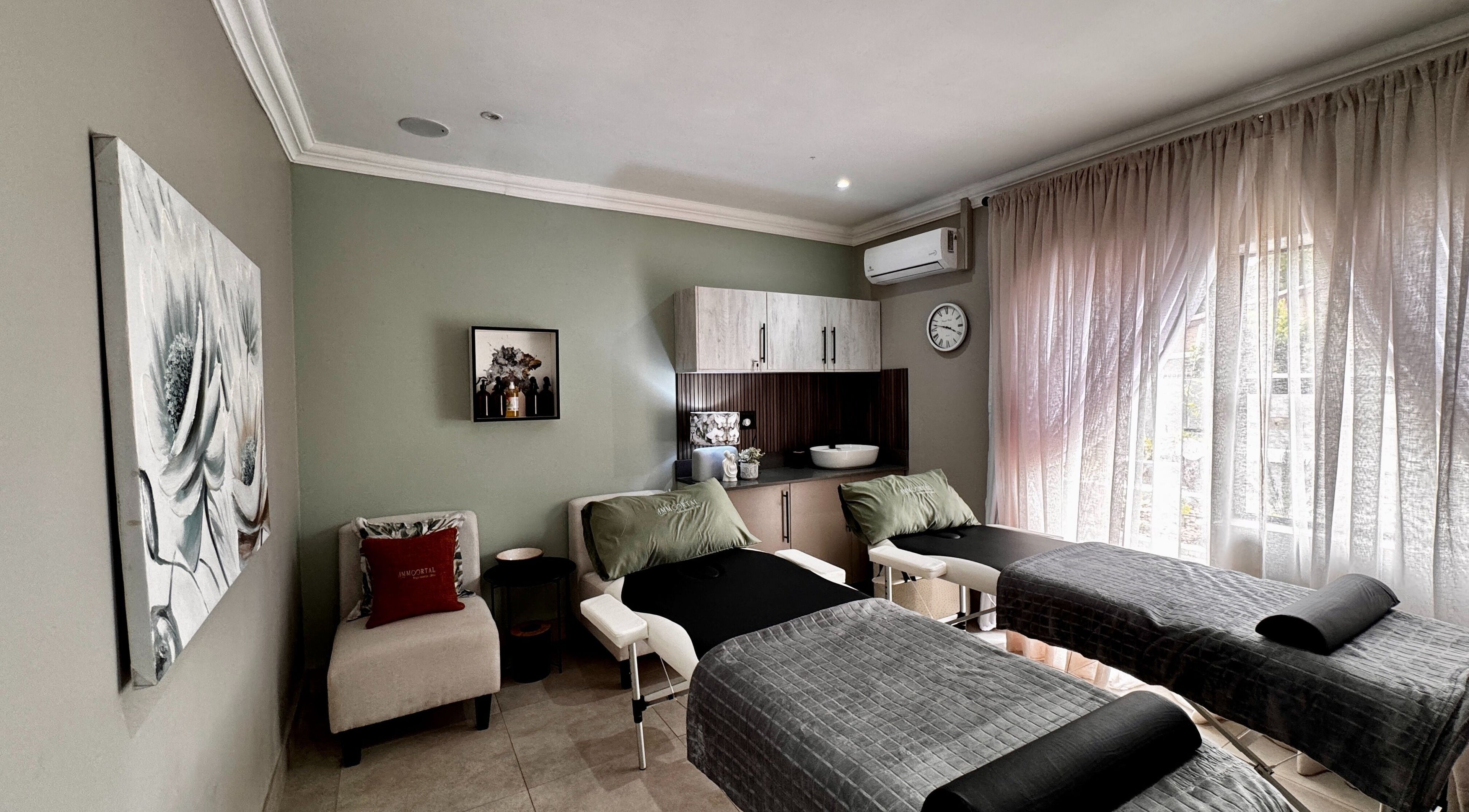 Luxurious treatment room at Immortal Rejuvenation Clinic, Newcastle, Kwazulu-natal, ZA with massage tables and elegant decor.