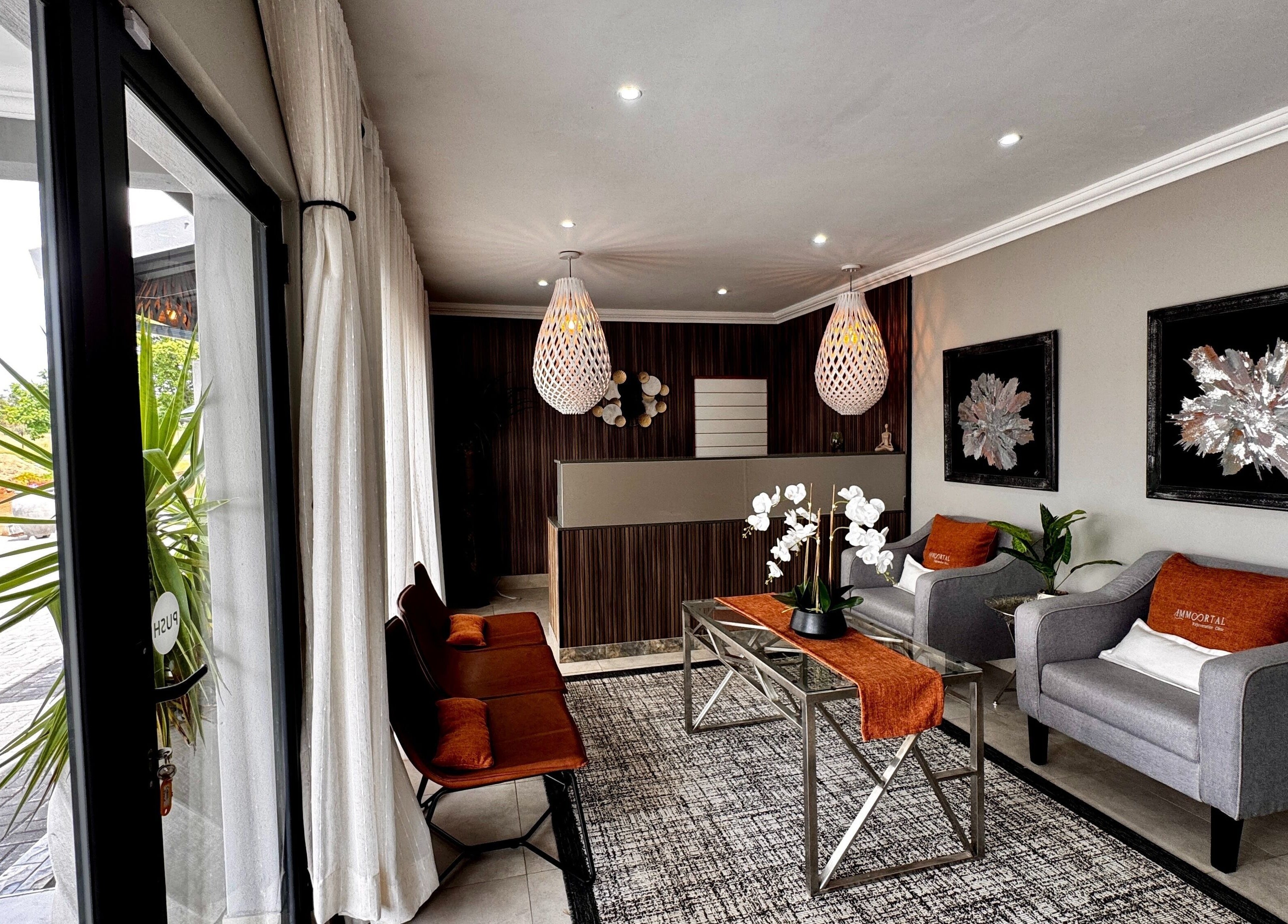 Reception area at Immortal Rejuvenation Clinic, Newcastle, Kwazulu-natal, ZA with modern decor and seating.