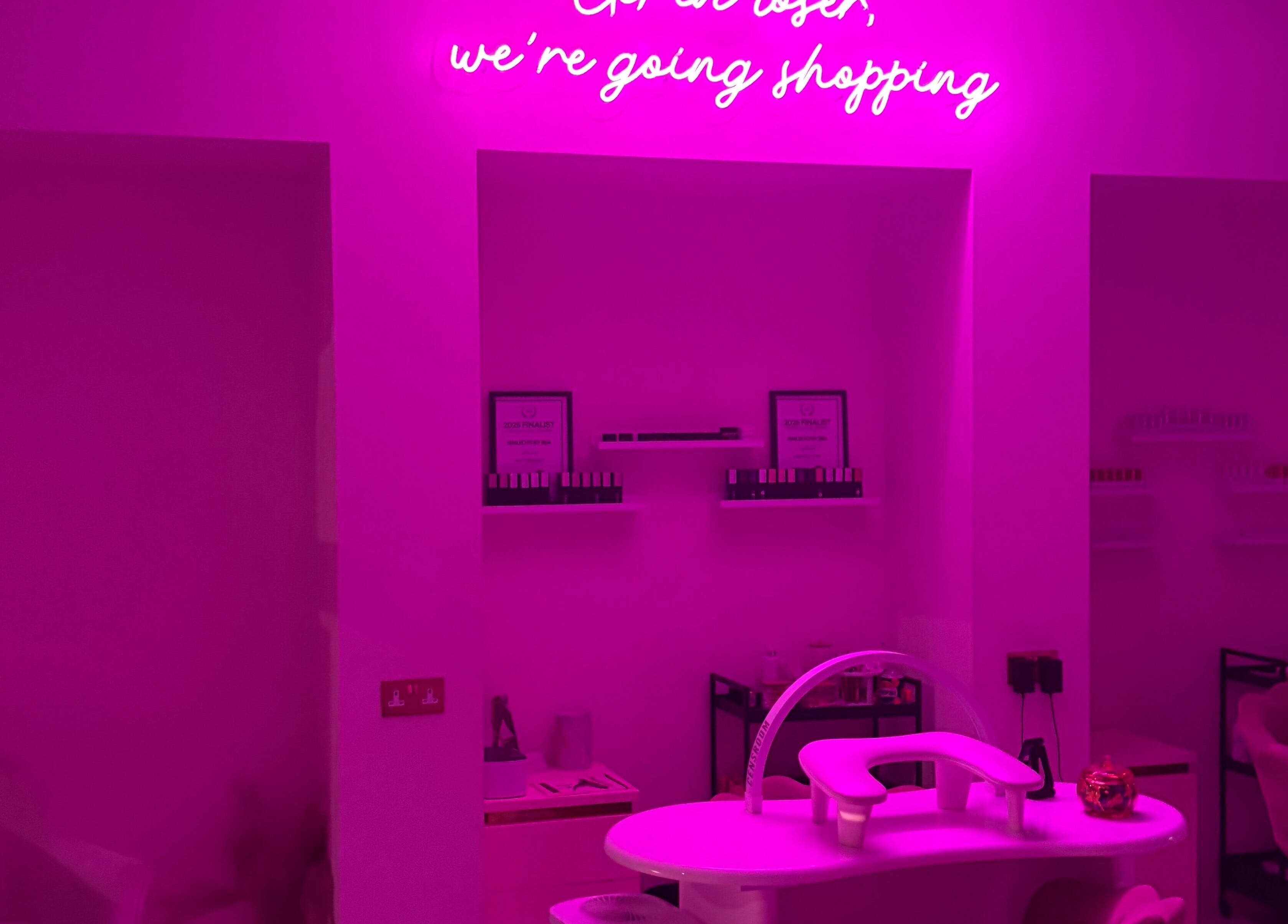 Vibrant pink nail station at The Nail Rituals, Exeter, England, GB, featuring chic neon decor.