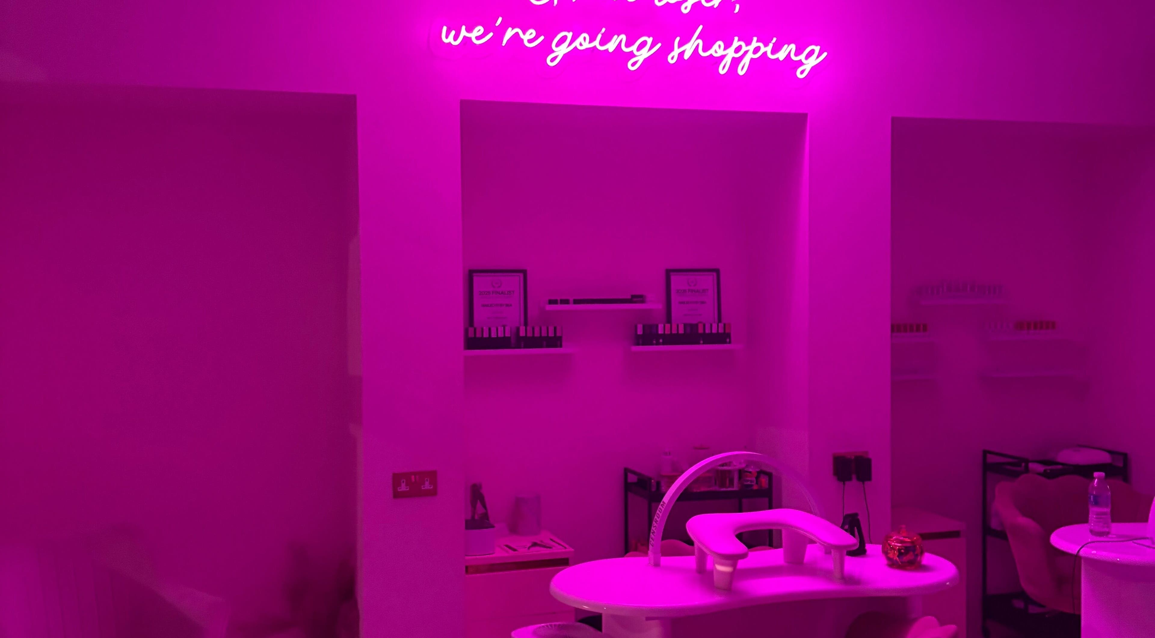 Vibrant pink nail station at The Nail Rituals, Exeter, England, GB, featuring chic neon decor.