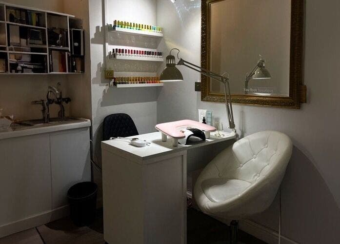 Cozy nail station at HASO LONDON nail and beauty, London, England, GB with plush seating and nail color display.