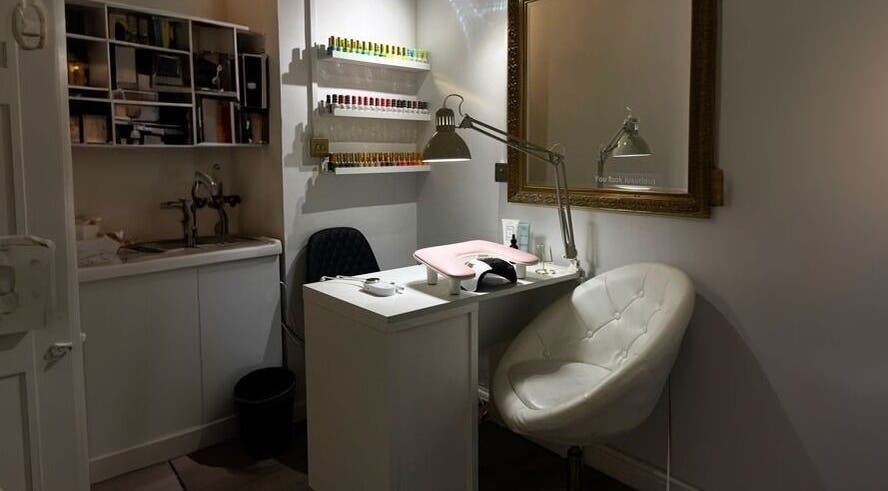 Cozy nail station at HASO LONDON nail and beauty, London, England, GB with plush seating and nail color display.
