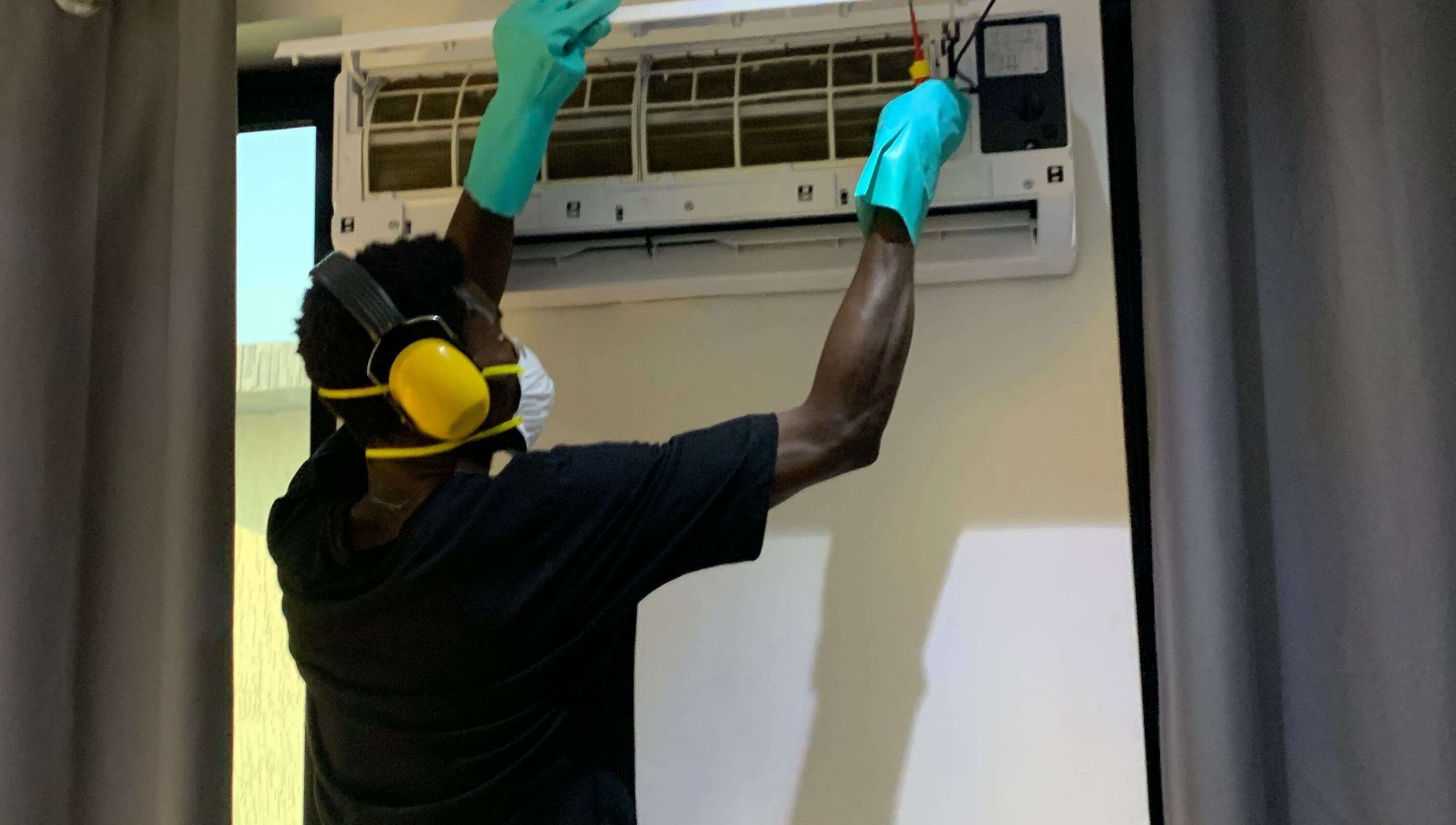 Technician servicing AC unit at Chillboss AC.Services, Adenta Municipality, Greater Accra Region, GH.