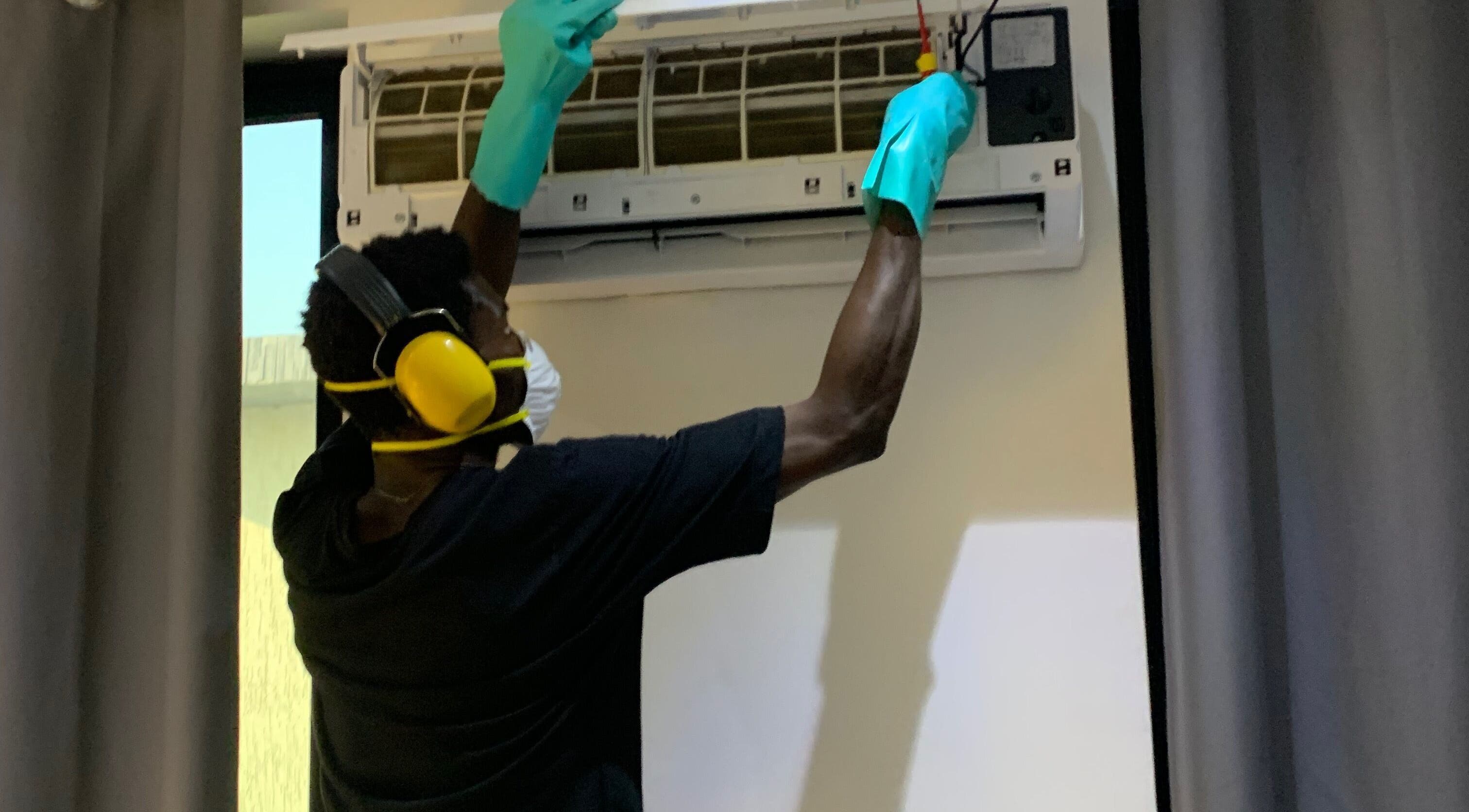 Technician servicing AC unit at Chillboss AC.Services, Adenta Municipality, Greater Accra Region, GH.