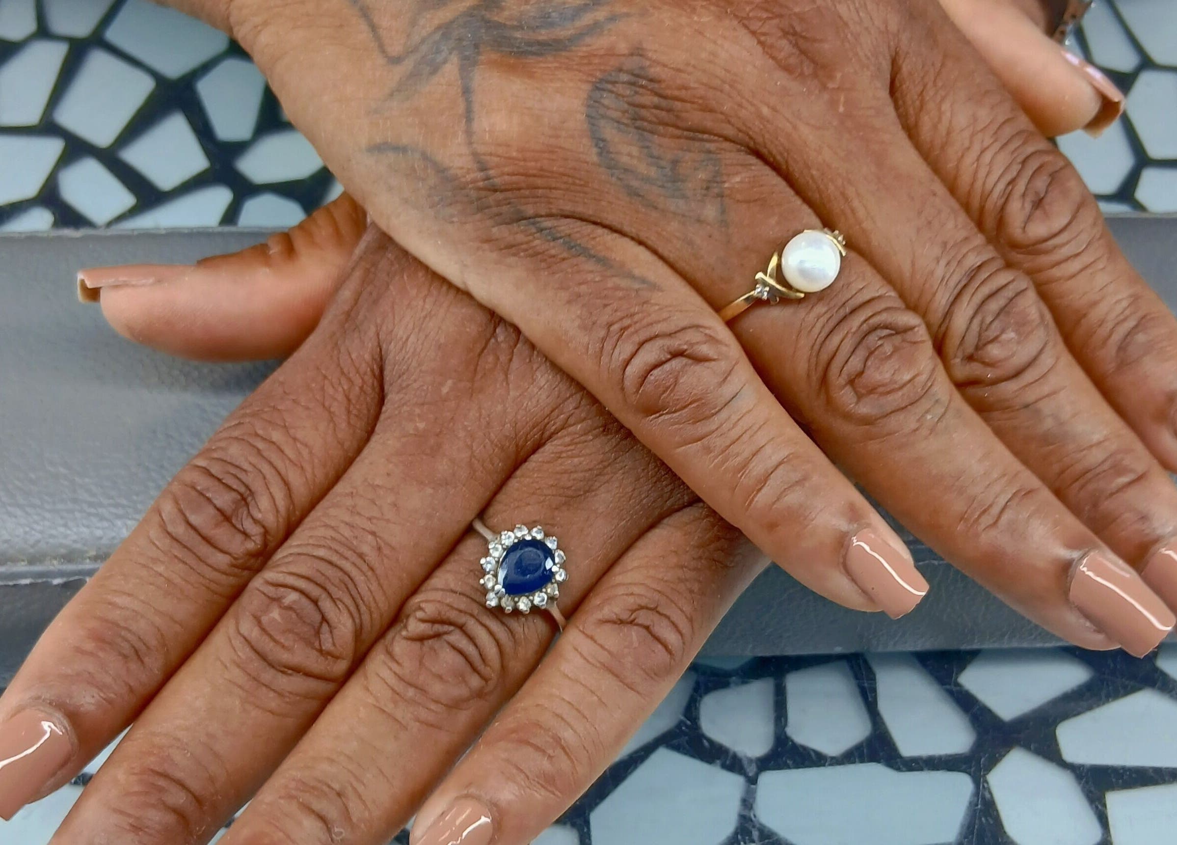 Stylish manicure with nude polish and rings at Golden Phoenix Nails, Koolbaai, Sint Maarten, SX.