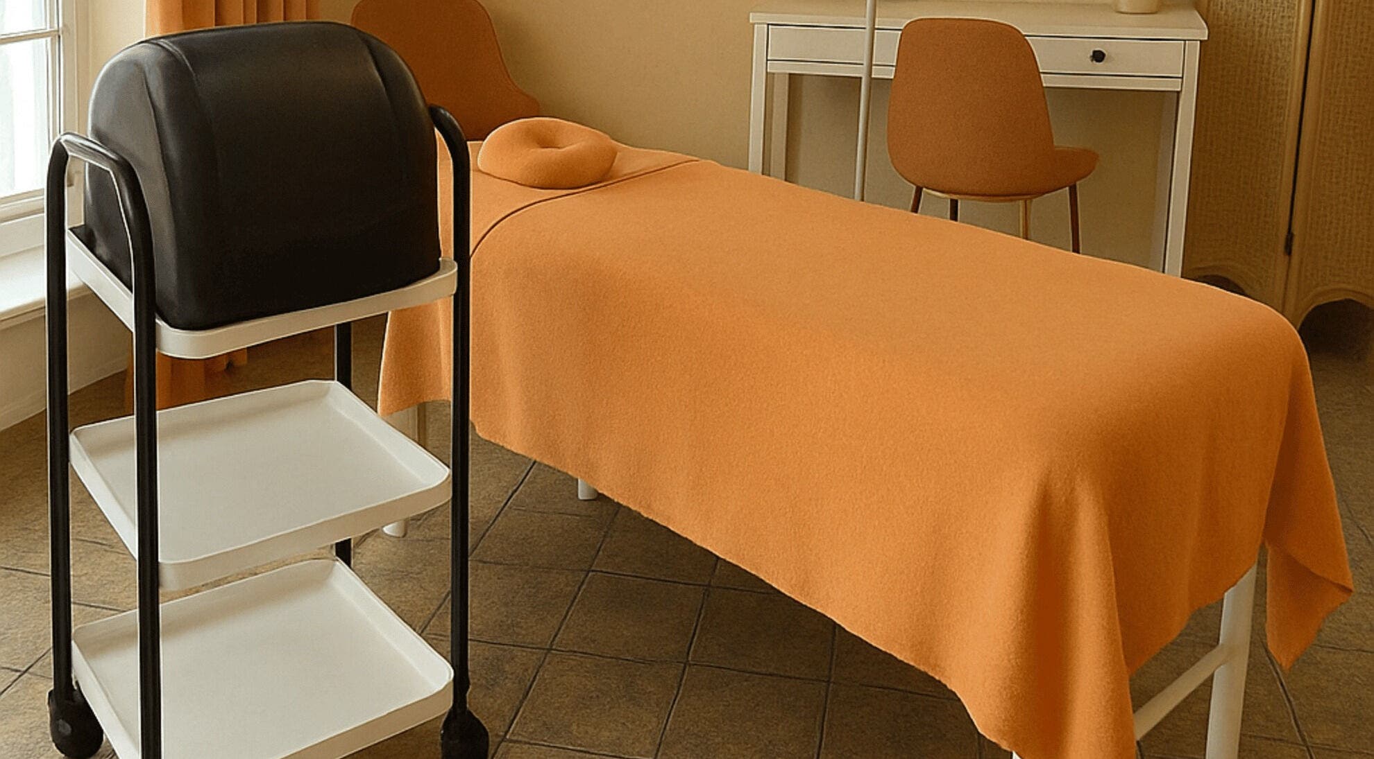 Calm therapy room at Discreet Aesthetics, London, England, GB with treatment bed and shelving unit.